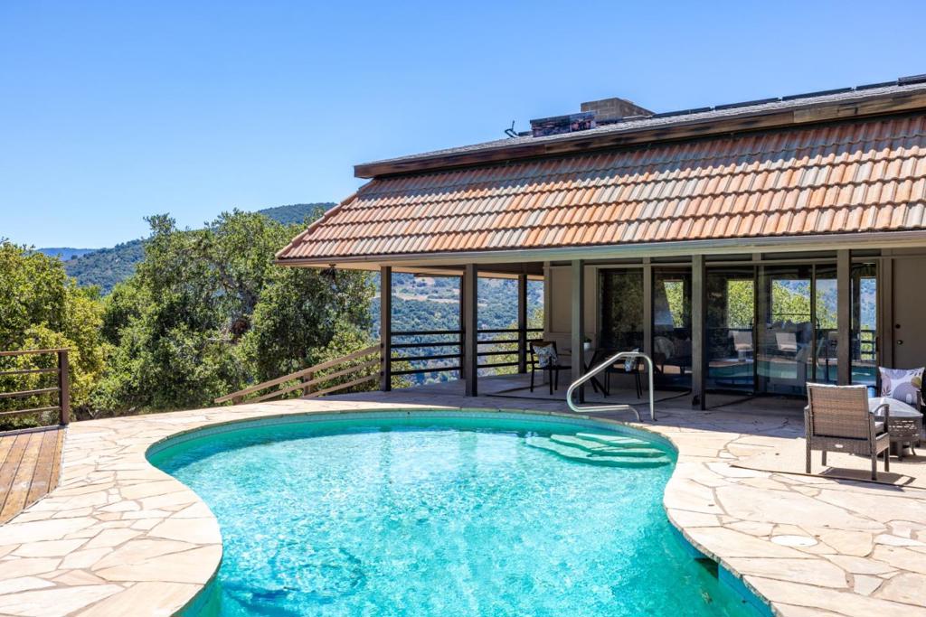 Refreshingly cool, crystal blue waters wash away the impurities of the day as you take respite with a sunset swim beneath purple Carmel Valley skies here at this distinctive home. This unique offering comes with two separate parcels. You don't need to travel all the way to Provence to live that healthful, sensual Mediterranean lifestyle by which adherents elevate themselves through their connection to the bare essential. Creativity, sunlight, and intimacy with Mother Nature define the wholesome existence that awaits you here at this property with unfiltered views that stretch all the way to the Monterey Peninsula. A hillside residence that lives like a single-level studio, it is ideal for those craving simplicity on the day-to-day, yet desiring unrestricted access to world-renowned destinations along the Central Coast. Carmel Valley Village, with its abundance of tasting rooms, wineries, charming boutiques, and unassuming cafes, is just a few minutes away, as is Garland Ranch Regional Park, where you can hike in peace for hours. In the evenings, with a fire crackling in the wood-burning fireplace, relax in your living room as you watch stars form a ceiling over the sleeping valley. This place proves you don't have to go off-grid to live a purposeful life that is purely your own.