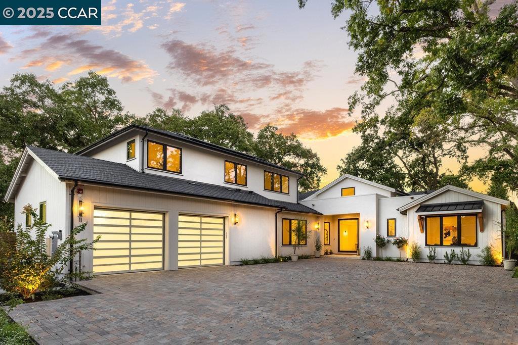 A true architectural masterpiece designed by renowned Steven Kubitschek, this contemporary transitional estate blends modern sophistication with timeless elegance. Behind a private gated entrance, the motor court and paver-lined drive set the stage for a grand welcome. Step through the striking pivot glass front door into a space defined by refined craftsmanship and cutting-edge design. Fleetwood and Andersen multi-slide pocket doors invite natural light and seamless indoor-outdoor flow, while designer lighting and extensive custom millwork—including wainscoting and moldings—add layers of detail throughout. The heart of the home features a show-stopping kitchen adorned with Italian marble, high-end Wolf appliances, and a chef’s kitchen complete with wine storage and juice refrigerator. Every finish has been curated to perfection—from oak-engineered wood floors and Porcelanosa tiles imported from Spain, to Kohler x Studio McGee fixtures and designer garage doors. Smart home readiness includes Lutron automation, a multi-zone speaker system, and hardwired surveillance throughout. Professionally landscaped front gardens set the tone, while the expansive backyard offers a blank canvas for a custom pool, spa, outdoor kitchen, and more.