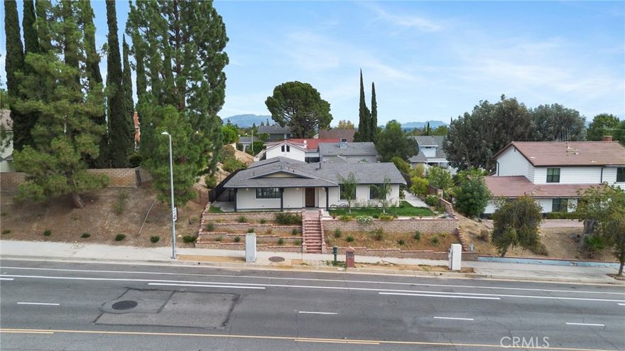 Welcome to 11410 Reseda Blvd, a beautifully reimagined and fully expanded 4-bedroom, 3.5-bathroom home in the highly sought-after Porter Ranch community. Thoughtfully redesigned and permitted, this residence now spans approximately 2,100 sq. ft., including a stunning new primary suite retreat with spa-like ensuite bath, dual closets (a spacious walk-in for her and a custom built-in for him), and designer details throughout. The heart of the home is the gourmet kitchen, showcasing quartz countertops, soft-close custom cabinetry, and premium appliances, seamlessly flowing into a bright and open-concept living area with recessed lighting and sleek modern flooring. Each bathroom has been crafted with sophistication, featuring floating vanities, LED mirrors, walk-in showers, and luxurious finishes that elevate everyday living. Every major system has been updated for peace of mind, including a new roof, HVAC with ducting, full house rewiring with upgraded electrical panel, new plumbing, insulation, tankless water heater, dual-pane windows and doors, smooth stucco, and cement siding panels exterior, plus fresh drywall throughout. Outside, the professionally landscaped backyard is a private oasis with palm trees, a new irrigation system, and a brand-new Jacuzzi perfect for relaxation or entertaining. Completing this exceptional property is a finished 2-car garage with ADU potential (buyer to verify), offering an exciting opportunity for added value or rental income. Blending modern design, high-quality upgrades, and functional living, this move-in ready home is the perfect opportunity to enjoy the best of Porter Ranch living.