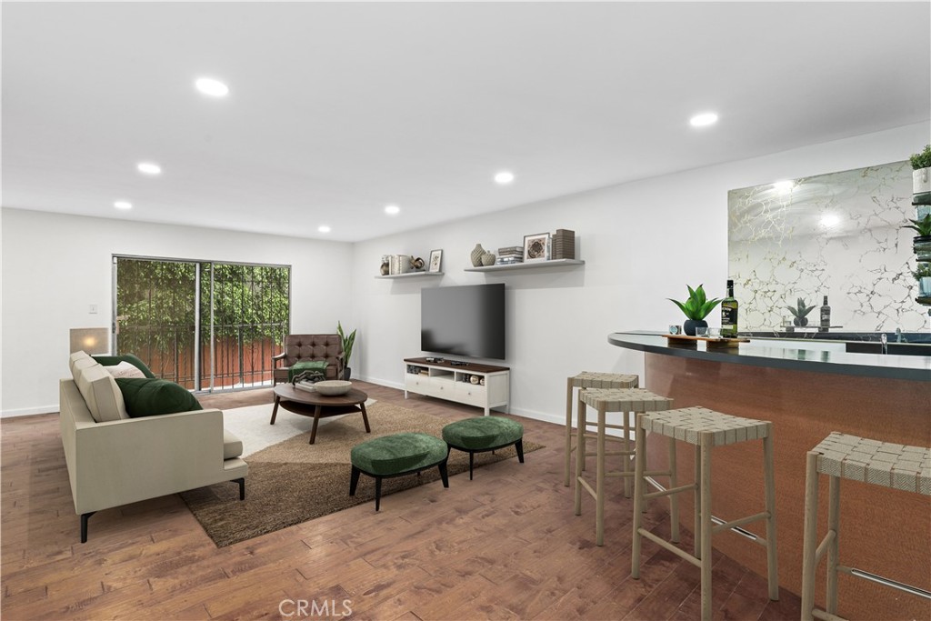 REFRESHED & RENOVATED UNIT! Introducing this perfect blend of comfort and convenience in this spacious 2-bedroom, 2-bathroom condo boasting 1,312 sq. ft. of thoughtfully designed living space. Located in the heart of West Hollywood, this condo is a true gem. The galley style kitchen has been renovated that features a newer stove and dishwasher, new tile flooring, new quartz countertops and sink. An inviting open-concept dining and living area details newer wood flooring, new recessed lights, fresh painted walls, an attached wet bar for entertaining and a balcony/patio area for outdoor allure. A stylishly designed full bathroom with eye-catching wallpaper is near the entry. The secondary bedroom has ample space with large windows for natural light. The primary suite is designed perfectly featuring wide windows, a spacious walk-in closet and a 3/4 bathroom with dual sinks. Another tremendous feature is a newer HVAC system with central heating and air for year-round comfort. Enjoy the perks of an HOA that offers a pool, jacuzzi, community laundry room, bike rack area and two dedicated side by side parking spots for added convenience. You are just moments from Santa Monica Blvd, Sunset Blvd, Gelson’s Market, Melrose Ave, and an endless array of shopping, dining, and entertainment options!