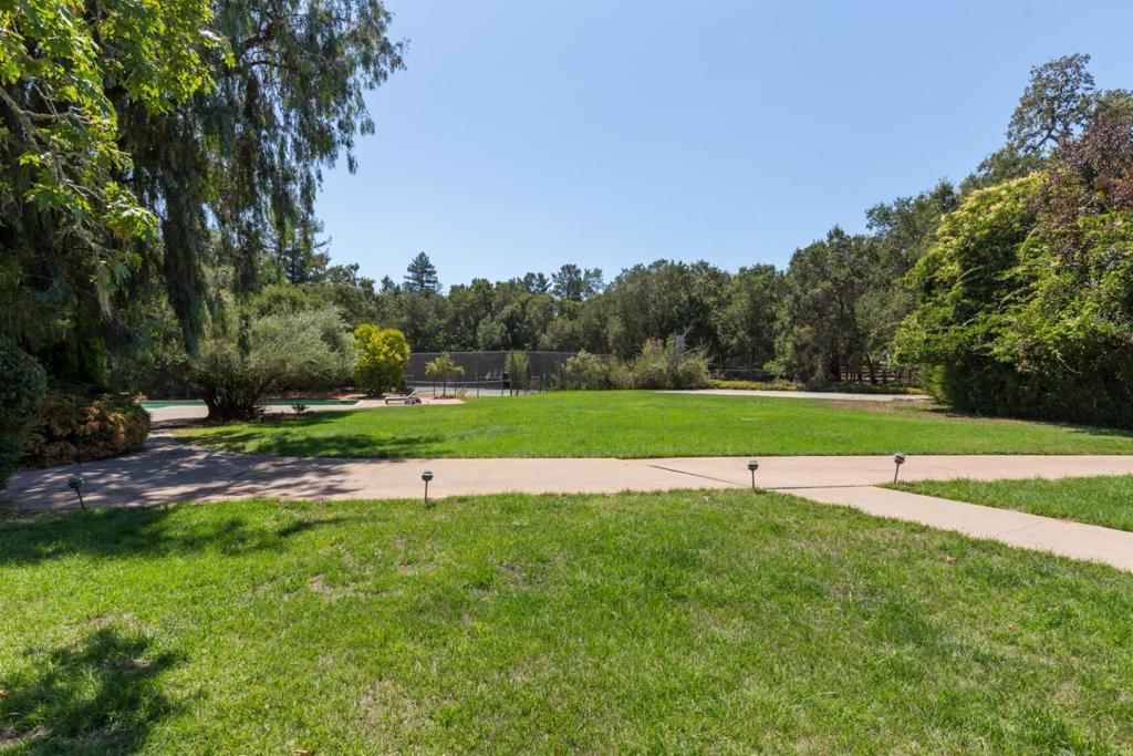 10+ location in Woodside School District. One of the best lots in Woodside. Quiet country lane off, just off historic Mountain Home Road, this property awaits your estate home. The lot of approximately 3.84 acres offers the utmost in privacy. The land is level with sun-swept open expanses of lawn and meadows with mature trees and perimeter foliage that enhances the privacy. Owned by the same family for more than 65 years, the property comprises a vintage ranch home and caretaker cottage, pool, tennis court, and sport court. This premier central Woodside location is bordered by legacy properties, benefits from access to acclaimed Woodside Elementary School (K-8), and is less than one mile from the town center.