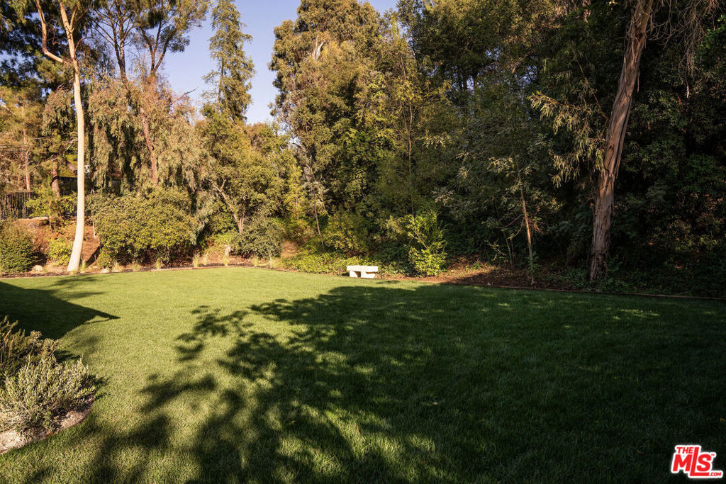 Step into a world of architectural elegance and timeless beauty at 2821 Roscomare Road, a fully gated, 1.16-acre estate meticulously reimagined by the visionary House of Rolison. Nestled in the exclusive enclave of Bel Air, this extraordinary property is more than a residence - it's a sanctuary. From the moment you enter, you're enveloped in an inviting warmth and architectural delight, where every space tells a story. Accessorized by the curated treasures of Olive Ateliers, the home's interiors are a living gallery of style and character. This 4-bedroom, 4.5-bathroom retreat spans over 4,500 sq. ft. on a single level, with each bedroom offering a private ensuite bathroom. Upon entering, the great room, with its original cemented brick fireplace, invites cozy gatherings while radiating a sense of history and charm. In the heart of the home, the kitchen is an artisanal masterpiece featuring a La Cornue stove, leathered black granite countertops, and exquisite Calacatta Viola marble backsplash accompanied by a 9.5-foot island. A Miele espresso maker and custom cabinetry add modern functionality to this culinary haven. The primary suite is a realm of luxurious tranquility, complete with an imported glass ceiling overlooking the bathroom, with a black marble shower and sauna providing an indulgent, spa-like retreat. Throughout the home, fine details such as Emtek hardware and Lo & Co finishes in the master bath, kitchen, and laundry rooms create a cohesive thread of luxury. Every room reveals itself as a chapter in the story of this home, layered with unique, thoughtfully crafted elements.Outside, the soccer-field-sized yard, sparkling pool, and spa offer a sanctuary of recreation and leisure, ideal for both intimate relaxation and grand gatherings. This impeccable estate offers privacy and exclusivity, all just moments away from the vibrant life of Los Angeles.