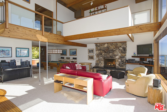 Located on a sandy stretch of beach behind "waterfall rock" lies this absolutely wonderful architectural beach home. Beautiful entrance with lush landscaping and koi pond directs you to a dramatic entry with open living, dining and kitchen, and walls of glass which provide for dramatic ocean views, and an expansive beachfront deck with steps to the beach. A billiard's area opens to a separate deck with spa. Upstairs is an incredible master suite with bedroom perched above the beach offering panoramic views. There is another bedroom and bath, and an office which opens to the living areas below to enjoy the incredible views. There is also a guest apartment with kitchen, bath, fireplace, and its own entrance and separate access to the beach.