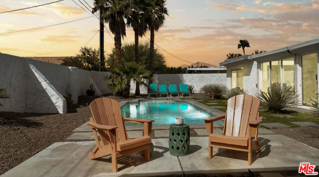 Step behind bold orange gates and sleek privacy walls into your slice of mid-mod magic in Palm Springs. This fully-furnished stunner is the ultimate year-round retreat or weekend getaway, where groovy design meets everyday luxury. Inside, enjoy single-level living with modern lines, mountain views, and retro-cool vibes throughout. The luxe primary suite is a vibe all its own, think spa bathroom with skylight, soaking tub, oversized rainfall shower, and a chill lounge space that opens to the yard. Out back, it's pure Palm Springs paradise: west-facing for golden sunsets, with a sparkling saltwater pool and spa, custom pergola, fire pit, and bocce ball court for your soiree-ready lifestyle. Inside, the open-concept living and dining area pops with a painted brick wall, Sputnik chandelier, and track lighting. The galley kitchen delivers style and function with dark stone countertops, skylights, and stainless appliances: two guest bedrooms, a stylish hall bath, and a breezy sunroom complete the space. You own the land (fee simple), there's no HOA, and the prepaid solar lease keeps things energy-smart. With a 2-car garage, off-street parking, and every designer detail in place, this one's move-in ready. Just bring your swimsuit, shades, and a taste for the good life.