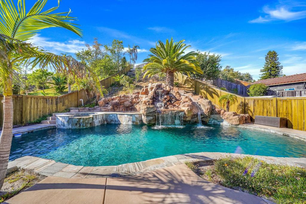 Welcome to your new oasis in the desirable Rancho Del Rey neighborhood of Chula Vista! This exceptional 5-bedroom, 3-bathroom home features an expansive backyard, truly a private retreat, complete with a sparkling deep pool, a relaxing spa with captivating water features and a thrilling water slide. You'll also discover a generously sized patio perfect for entertaining and ample grassy areas for recreation. The expansive interior boasts a thoughtfully designed layout, including a downstairs bedroom and full bath for convenience, alongside four additional bedrooms upstairs. Enjoy distinct living areas with both a formal living room and a separate family room, a dedicated formal dining room, and a charming breakfast nook in the well-appointed kitchen. This home enjoys the benefits of a community known for its well-maintained homes, excellent schools, and convenient access to shopping, dining, and parks.