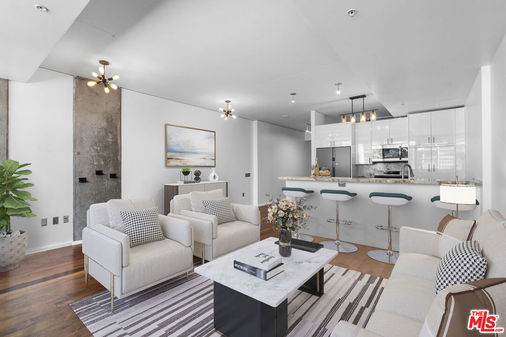 Welcome home to your west-facing 1-bedroom unit in the highly desirable South Park neighborhood of DTLA. This beautifully updated condominium features a private balcony with sweeping views of the DTLA skyline. Inside, the home boasts a remodeled kitchen with sleek white custom European cabinetry, Patagonia Granite Quartzite polished countertops, and new stainless steel appliances. The open layout flows seamlessly into the living space, while frosted glass sliding doors offer stylish privacy for the bedroom. Additional upgrades include fresh paint throughout and an updated bathroom with a new vanity, mirror, and toilet. Large in-unit laundry room and central HVAC. Enjoy peace of mind with a 24-hour concierge and on-site management. The community includes world class resort-style amenities, including pool and spa, BBQ grill, multiple seating areas, and a rooftop lounge with TV and an outdoor deck. The state-of-the-art fitness center on the top floor has stunning south-facing views and a fresh air deck. Located just minutes from LA Live, Whole Foods, Crypto.com Arena, and the city's best dining, shopping, and entertainment. This move-in-ready unit combines luxury, convenience, and style. Don't miss out and schedule your private tour today!