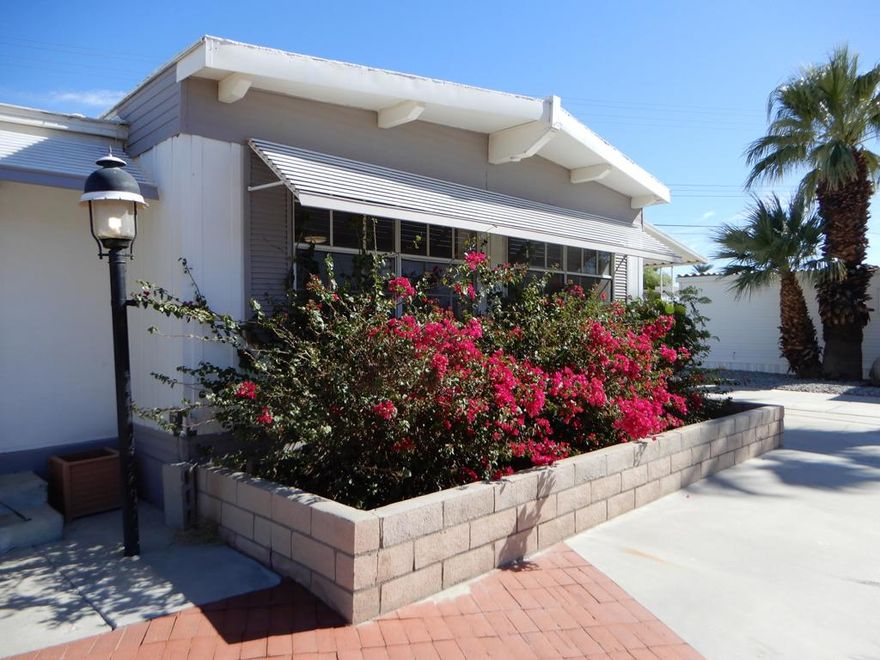 55+ The lowest monthly HOA fee. If you enjoy light, bright,  and natural sunlight, this is the home for you. It offers over 1700 square feet of living space.   2 bedroom and 2 bathroom open floorplan concept with golf course and mountain views from most windows.  The extra bonus room can easily be used as a 3rd bedroom for overflow company,  an office, craft room or artist studio. French doors lead to a private covered patio. This home has been updated and well maintained with attention to electrical, plumbing, laminate flooring, and lighting.  It has a separate laundry with massive storage. AND brand new heating and air. Tri-Palms Estates offers unlimited golf for 2 owners on title, pools, tennis, restaurant, bar and much more.