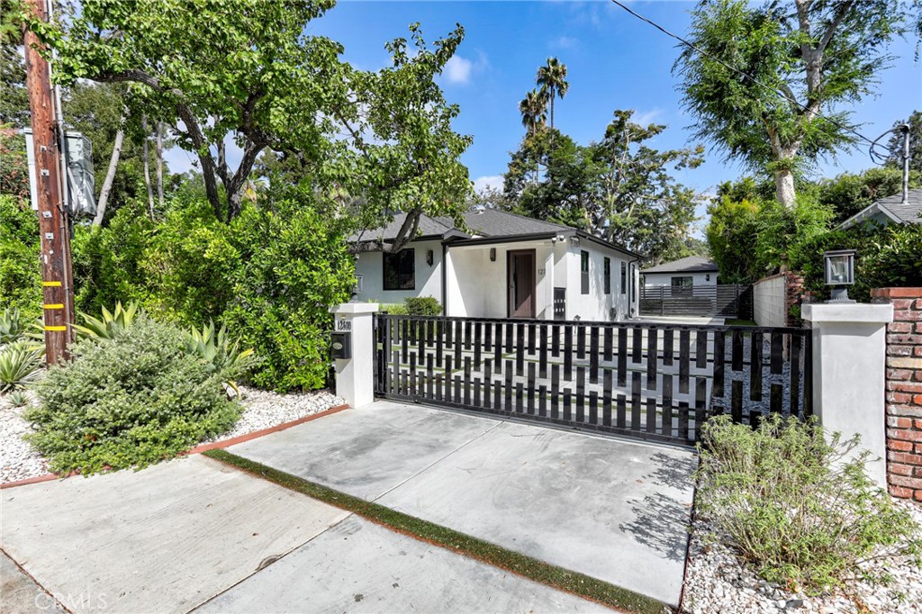 In the sought-after Beeman Park neighborhood sits a gated “mini estate” featuring a stylish main residence (12701 Kling), a permitted ADU (12699 Kling) and a sparkling POOL for year-round enjoyment. 3 BR+2 BA in main house. and studio, kithenette + 1 BA in the ADU. Fully remodeled about five years ago, the home blends modern design with timeless elegance. The open floor plan seamlessly connects the kitchen, dining and living areas, all oriented toward the pool & sitting areaS. The chef’s kitchen showcases a large white quartz island with soft gray veining, Carrera marble backsplashes, custom cabinetry, Zephyr wine cooler, Thermador appliances and high-end fixtures - crafted with every detail in mind. The open layout pulls you naturally from the elegant kitchen into the dining and living areas, and through Magnum multi-paneled folding doors to the pool, sitting areas and the ADU — blending indoor and outdoor: welcome to sunny California! The Bathrooms echo the same level of refinement with Carrera marble counters, sleek hardware and designer finishes. Additional highlights include new wood floors, upgraded windows, professional landscaped front & back yards… and much more. This private haven offers comfort, style, and an unbeatable location in one of Studio City’s most desirable neighborhoods: Beeman Park.