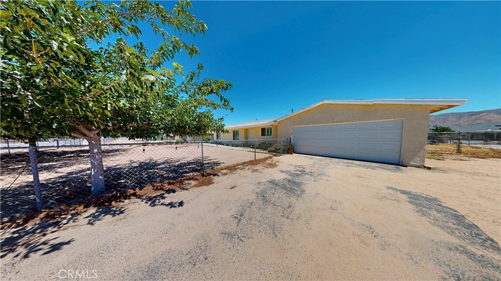Welcome to this beautifully upgraded single-story home featuring 3 bedrooms, 2 bathrooms, and 1,622 sq.ft of spacious living space on a sprawling 18,000 sq.ft Lot. The remodeled kitchen is a dream with quartz countertops, white shaker cabinetry, stainless steel appliances, and a spacious formal dining area that flows into a bright and inviting living room. The primary suite offers ample space with a bathroom featuring a modern vanity and a walk-in shower. Upgrades include laminate wood-like flooring, plantation shutters, modern vanities with granite countertop, a tankless water heater, and an upgraded A/C system for year-round comfort. The expansive backyard offers endless possibilities for entertaining, gardening, boat/RV parking or future expansion. This home is ready for its next owner to move in and enjoy!