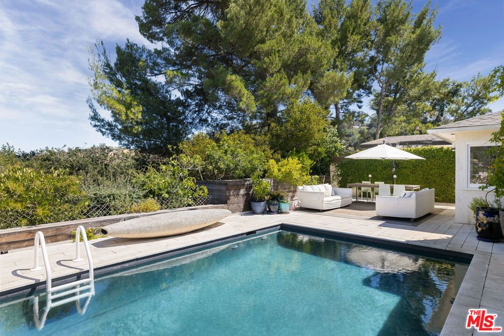 Have you ever dreamed of a chic private house with a view of the Hollywood Sign and a sparkling pool? With pretty natural light and bright spaces? Cozy and inspiring and open and inviting? With beautiful lines and sophisticated finishes? Where you could write a play and throw a party? With a fig tree? Well maybe dreams come true, because 8704 Hollywood Hills Road has all that and more. Head up Laurel Canyon, past romantic Pace Restaurant, the iconic Canyon Country Store and Wonderland School, where tucked away you'll find this perfect 3 bedroom, 2 bath, single story home. It's got a soaking tub with skylight, Cole & Son wallpaper, Viking range, Miele dishwasher, Subzero refrigerator, reverse osmosis water filtration, citrus trees, passion fruit, a rose and wildflower garden, ipe decking and gorgeous views. Come check it out!