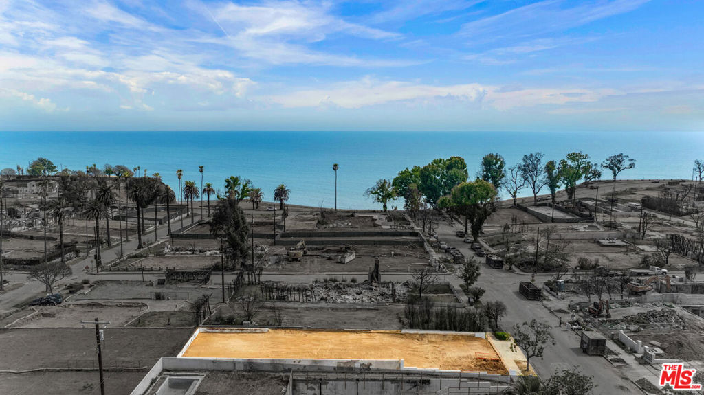 In the prestigious Via Bluffs of Pacific Palisades, this 7,503-square-feet prime homesite presents the opportunity to realize a legacy estate with sweeping ocean views. Prior to the wildfire event, the property was home to a Modern Spanish residence completed in 2019, with 7,199-square-foot interiors, 6 bedrooms, and 9 bathrooms. The upper levels captured dramatic views of the Pacific Ocean and Santa Monica Mountains, visible from both the second floor and a rooftop deck. Included in the sale are architectural plans (March 2018) for the former residence that feature a private elevator, chef's kitchen with butler's pantry, dedicated office, spacious primary suite, and a lower level retreat with luxury amenities including a home theater, wine cellar, and subterranean 2-car garage. Just moments from Palisades Village, the Riviera Country Club, and the rest of the Westside via Sunset and PCH, 410 Via De La Paz is a rare opportunity to build something extraordinary -- where vision meets value in a neighborhood defined by community, legacy, and lifestyle.