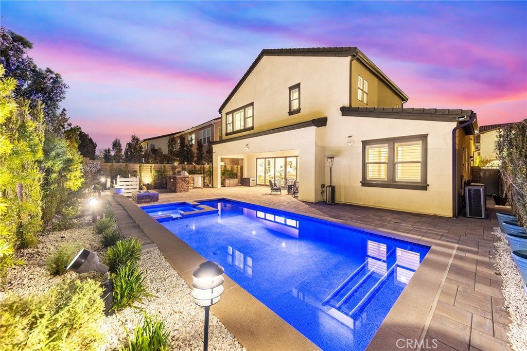 Welcome to luxury living in Great Park, Irvine. This spacious Lennar Capella Residence 1 at Cadence Park offers 3,754 sq. ft. with 4 bedrooms, 4.5 bathrooms, and sits on an ~6,000 sq. ft. lot. Featuring soaring ceilings, an open floor plan, and premium upgrades, this home blends indoor and outdoor living. The expansive great room flows seamlessly into the chef’s kitchen with oversized island and walk-in pantry. Sliding doors open to a California room with fireplace, dining space, and serene water feature. The luxurious primary suite features a spacious bedroom and spa-inspired bath, while a main-floor guest suite provides added convenience and each additional bedroom includes its own private en-suite. The backyard is a private oasis with a sparkling pool, built-in barbecue, lush landscaping with fruit trees and flowers, multiple seating areas, and walking paths. Located on a quiet cul-de-sac within walking distance of award-winning schools, parks, and resort-style amenities, this home combines elegance, comfort, and the ultimate Irvine lifestyle. Don’t miss the opportunity to make this prestigious residence your own.