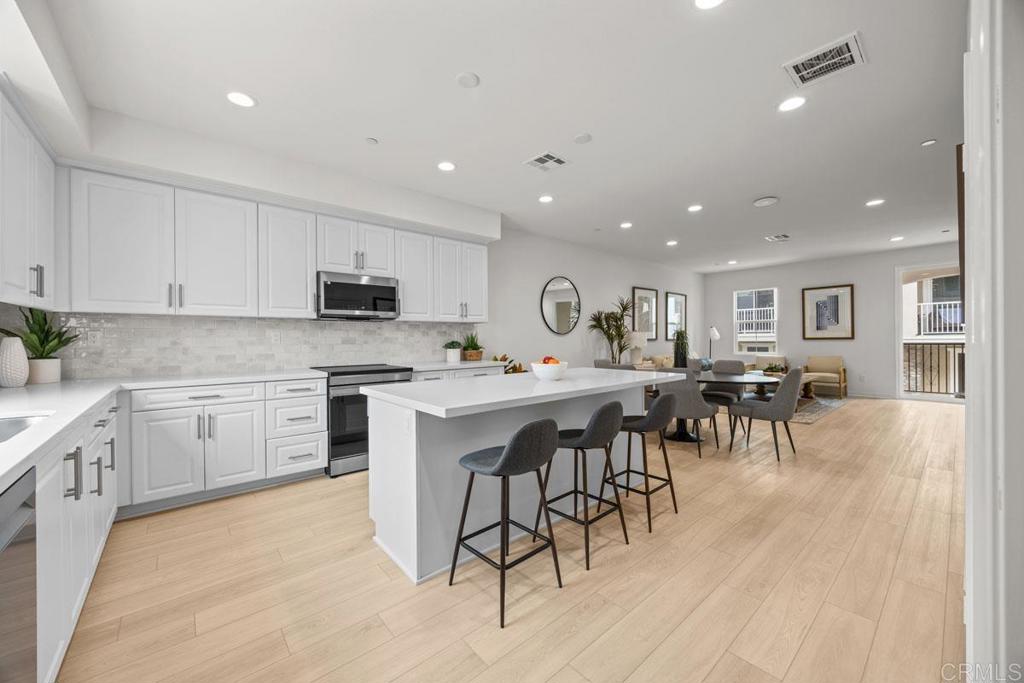 Experience elegance and modernity in this impeccable, three-story home, which showcases an open floor plan with 9-ft. ceilings and luxury vinyl plank flooring. Upstairs, the kitchen boasts an island, thermofoil cabinets, quartz countertops, Samsung® stainless steel appliances and single-basin sink with sleek pull-down faucet. The balcony provides the ideal setting for outdoor entertaining and leisure. The third-floor primary bedroom features plush carpeting, a walk-in closet and connecting bath that offers cultured marble countertops, a dual-sink vanity, walk-in shower and ceramic tile flooring. Additional highlights include a solar energy system, LED lighting, electric charging station pre-wiring and smart thermostat. Don't miss the opportunity to own this exceptional new construction home. Schedule your private tour today!
