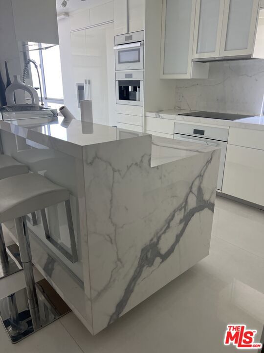 This is one of the finest residences at Ocean Towers, offering the ultimate in coastal luxury and design. A converted and oversized 2-bedroom + open den/office, 2.5-bath home (this unit is a legal 3 bed, 3 bath on public record and has been converted to a large 2 bedroom with an open den/office area. Can be converted back by Buyer), this entertainer's dream showcases beautiful ocean and canyon views from nearly every room. The chef's kitchen is fully outfitted with top-of-the-line Miele designer appliances, including a built-in cappuccino machine, and wrapped in elegant porcelain slabs. Select walls throughout the unit are clad in white porcelain making it feel very light and airy. Venetian plaster ceilings and walls, Lutron smart lighting, integrated surround sound with LED and RGB mood lighting, and electronic window shades bring cutting-edge automation and ambiance to every corner. The exquisite primary suite features pocket sliding doors that open directly to the view, delivering an elevated sense of serenity and openness. Ocean Towers is a full-service building offering 5-star amenities including 24-hour concierge and security, valet parking, pool, spa, gym, and more. Showings to begin after July 15th. Professional photos to be uploaded in the coming week.