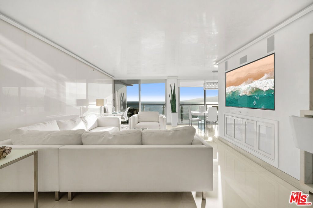 This is one of the finest residences at Ocean Towers, offering the ultimate in coastal luxury and design. A converted and oversized 2-bedroom + open den/office, 2.5-bath home (this unit is a legal 3 bed, 3 bath on public record and has been converted to a large 2 bedroom with an open den/office area. Can be converted back by Buyer), this entertainer's dream showcases beautiful ocean and canyon views from nearly every room. The chef's kitchen is fully outfitted with top-of-the-line Miele designer appliances, including a built-in cappuccino machine, and wrapped in elegant porcelain slabs. Select walls throughout the unit are clad in white porcelain making it feel very light and airy. Venetian plaster ceilings and walls, Lutron smart lighting, integrated surround sound with LED and RGB mood lighting, and electronic window shades bring cutting-edge automation and ambiance to every corner. The exquisite primary suite features pocket sliding doors that open directly to the view, delivering an elevated sense of serenity and openness. Ocean Towers is a full-service building offering 5-star amenities including 24-hour concierge and security, valet parking, pool, spa, gym, and more.