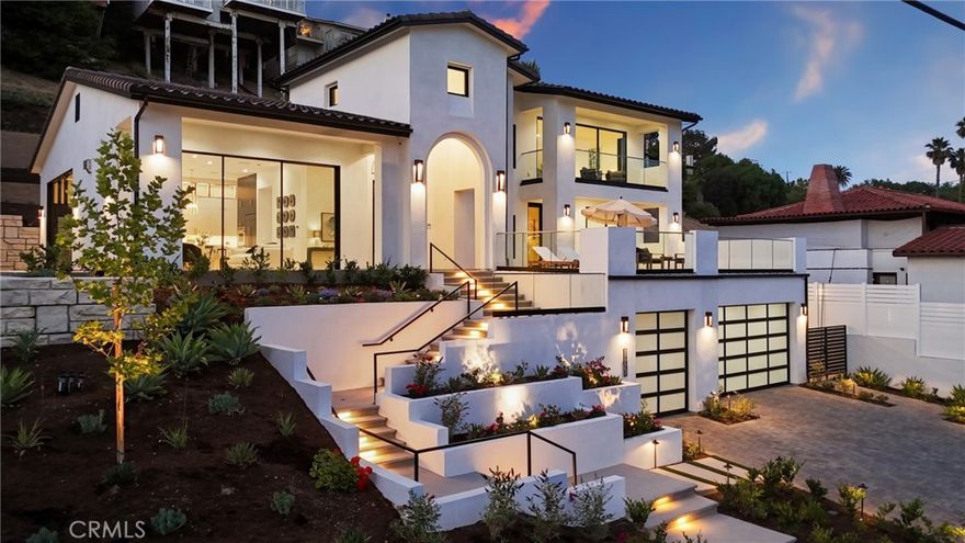 Perched atop an elevated 14,470 sq ft parcel with commanding views of Fashion Island and Catalina Island, this exceptional residence blends refined luxury with modern resilience. Newly completed by esteemed builder Fowler Villas, this 3,876 sq ft architectural statement features 4 bedrooms, 4.5 baths, and an uncompromising level of detail throughout. Beyond the stately façade, a grand permeable paver motor court welcomes guests with parking for up to 8 vehicles, in addition to a 3-car garage. Inside, soaring 12-foot ceilings, expansive Cortizo 10-foot sliding glass doors, and wide-open living spaces set the stage for elevated coastal living. The designer kitchen is a study in form and function, featuring dual-toned custom cabinetry by Stylite and Shinnoki, brushed brass hardware, glass-lit uppers, a 48'' 6 burner cooktop plus grill, and a full suite of professional-grade Wolf appliances such as: cooktop, oven, microwave drawer, and a chef’s hood. Also included is a Cove dishwasher, a pot filler, and a Subzero refrigerator and beverage center. An elegant butler’s pantry and built-in cabinetry add sophistication and practicality, while a striking 74-inch Napoleon fireplace anchors the living area in warmth and style. Three graciously appointed ensuite bedrooms are located on the main level, including a versatile flex room ideal for a game lounge, studio, or home theater on the bottom floor. Upstairs, the sumptuous primary suite commands breathtaking panoramic views, a sizable walk-in closet, spa-like bathroom with Kholer fixtures, a soaking tub, a step-in shower, and it is complemented by an additional flex space—perfect for a home office, private gym, or retreat. Thoughtfully engineered for convenience and peace of mind, the home is equipped with a windowed elevator by California Custom Lifts, as well as a  Savant smart automation systems for seamless control of lighting, climate, security, and entertainment. The residence includes fire sprinklers, closed eaves; as well as lush new landscaping approved for defensible space. A brand-new vinyl perimeter fence completes the eco-conscious outdoor environment. To add to the ambiance, there are speakers throughout the home. Structurally fortified with mechanical stabilization and gravity retaining wall systems, the home exemplifies lasting luxury and integrity. A rare offering of this caliber, combining panoramic views and cutting-edge design. Home is Turn-key and ready for its new owner.