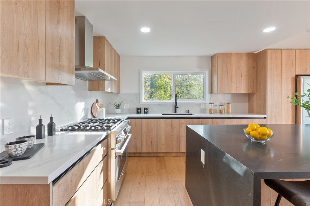Perched in the coveted South of Ventura Blvd neighborhood of Woodland Hills, this stunningly remodeled property offers a total of 3,500 square feet of luxurious living space, including a beautifully designed 2,740-square-foot main residence and a fully upgraded 800-square-foot ADU—perfect for guests, rental income, or multi-generational living. Elevated in the hills, the property boasts panoramic city light views that serve as a breathtaking backdrop to this elegant retreat.
The main residence features three spacious bedrooms and three beautifully designed bathrooms. At the heart of the home is a chef’s dream kitchen, outfitted with brand-new Signature appliances, custom oak cabinetry, Bedrosians Calcatta Milan quartz countertops, and a striking Brussels Blue quartz island.
The primary suite is a sanctuary of comfort, complete with a custom walk-in closet, a built-in sauna, and a spa-inspired bathroom showcasing Venetian plaster shower walls, limewashed finishes, and brushed bronze hardware. Throughout the home, thoughtful upgrades include smooth stucco walls, recessed lighting, Pottery Barn and Arhaus light fixtures, and Arcadia European oak flooring. Expansive new Mangaris decks with steel cable railings extend the living space outdoors, offering the perfect vantage point to enjoy the serene surroundings.
The ADU mirrors the quality and craftsmanship of the main home, featuring a modern kitchen with Samsung appliances, white shaker cabinets, Calacatta Caramel quartz countertops, and elegant finishes. Additional highlights include recessed lighting, central AC and heating, and matching oak flooring, ensuring a seamless integration of style and comfort.
Located just moments from the 101 Freeway, Whole Foods, Trader Joe’s, and the area’s finest dining and shopping, this home offers a rare combination of privacy, convenience, and elevated living in the hills of Woodland Hills.