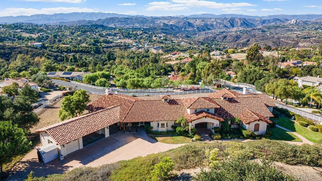 First time on the market! Custom-built in 2003, this stunning 3BR/3.5BA estate sits on 2.33 acres with panoramic western views. Vaulted ceilings, open beam construction, and fine craftsmanship throughout. Spacious primary suite features fireplace, ornate custom doors, en-suite bath, and private patio. Each guest bedroom includes its own en-suite bathroom. Private office ideal for remote work. This is one of those homes where the photos don't exaggerate - these spaces truly are large-scale with plenty of room in every part of the home. The Laundry Room has space for its own refrigerator! Expansive outdoor patio with pool, perfect for entertaining or relaxing. Horse-friendly property with fully enclosed area suitable for equestrian use. 3-car garage and ample parking. Views abound from the Living Room, Kitchen, Dining Room, Office, and Primary - not to mention from the back patio! A rare opportunity to own a beautifully designed custom home in the desirable foothills of Fallbrook!
