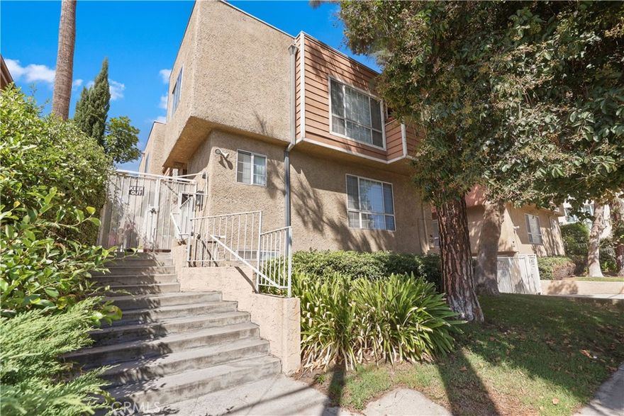 Welcome home to your very own townhome located in the heart of Van Nuys within a private gated community that feels safe and secluded. Pull right into your spacious two car garage with direct access and walk up to the first floor which has your bright living room with large sliding glass doors, a cozy corner fireplace and an open concept dining room and kitchen. The kitchen has all stainless steel appliances and bar seating with modern quartz countertops. Adjacent to the living room is a powder room for your guests. On the second floor, you'll find both bedrooms to be spacious and bright. The primary bedroom has a gorgeous newly remodeled bathroom with a sleek shower glass door enclosure, sitting bench and modern large format tiles. An affordable HOA and a sparkling blue swimming pool, also offering a bonus 3rd parking space for this unit! Located in the San Fernando Valley within minutes of the major 5 and 405 highways. Come see for yourself and welcome home!
