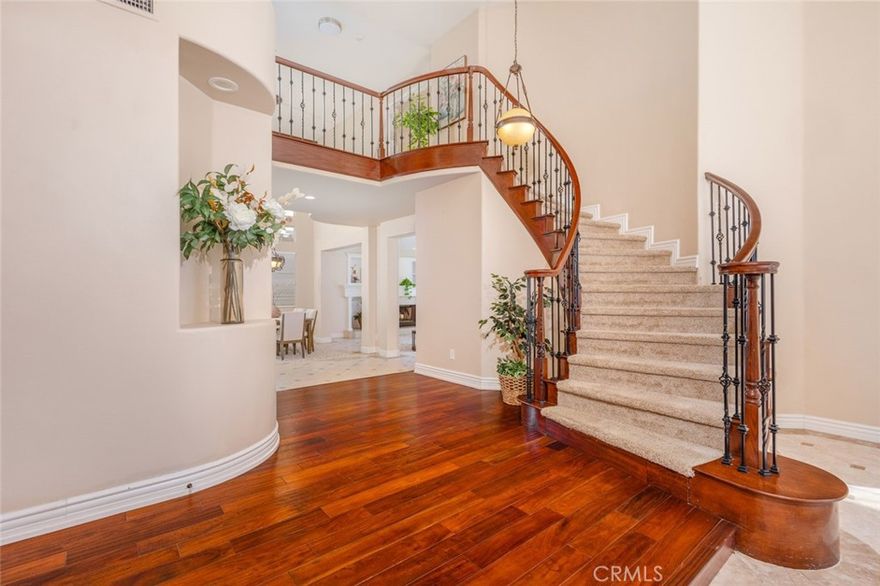 Welcome to this beautifully maintained 2-story home in the heart of Murrieta, offering 5 bedrooms, 3 full bathrooms & 3,176 sf of thoughtfully designed living space on a 7,841 sf cul-de-sac lot. This quality-built home is located in one of Murrieta's most desirable neighborhoods, Corta Bella, known for its family friendly atmosphere, well-kept surroundings, & convenient access to everything the area has to offer. The curb appeal shines with an inviting exterior, mature landscaping & a spacious 3-car garage. Step through the front door & you are greeted by a stunning curved wooden staircase that sets the tone for the elegance & craftsmanship of the home. Rich dark hardwood floors in the entryway create warmth & contrast beautifully with the neutral colors found throughout. The formal living room offers a cozy fireplace & high ceilings, making it an ideal space for entertaining. Adjacent to the living room is a spacious dining room, perfectly suited for holiday dinners & celebrations. The family room, featuring its own fireplace, flows seamlessly into the kitchen, creating a welcoming open-concept layout, perfect for family gatherings. The chef's kitchen is a standout feature of this home. With granite countertops, dark wood cabinetry, DBL ovens, built-in range, a large center island & a huge walk-in pantry, it offers both beauty & practicality. Downstairs, you'll also find a full bathroom & a generously sized bedroom, ideal for guests, in-laws, or a home office. Upstairs, the thoughtful design continues with 4 spacious bedrooms. The primary suite is a private retreat with its own fireplace & balcony overlooking the backyard, providing a perfect spot for relaxation. The en-suite bathroom includes dual sinks, a soaking tub & separate shower. The additional upstairs bedrooms are equally spacious. The backyard offers ample space for outdoor living, gardening & entertaining. This home is located within the Murrieta Valley Unified School District & is zoned for the highly rated schools including Antelope Hills Elementary, Shivela MS, & Murrieta Mesa HS. Families will appreciate quick access to both the 15 & 215 Freeways. You're just minutes from shopping including a brand new Costco, dining & entertainment such as the award-winning Temecula wineries. Murrieta is known for its vibrant community, beautiful parks such as Los Alamos Sports Park & welcoming neighborhoods. Combining space, style & a prime location, this quality-built Murrieta home is truly a rare find.