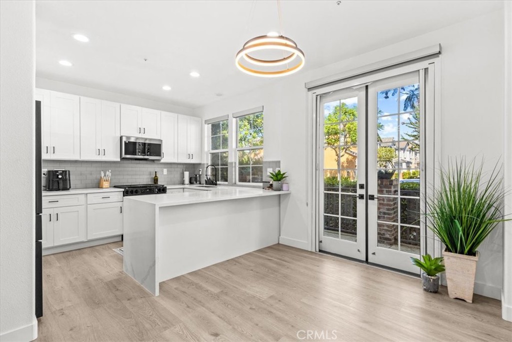This beautifully updated end-unit is flooded with natural light, giving the whole home a warm and welcoming feel. The upgrades are endless—brand-new luxury vinyl flooring, sleek quartz countertops, all-new cabinets and vanities, and fresh hardware throughout. The kitchen is both stylish and functional with stainless steel appliances, a breakfast bar, and a cozy dining nook. French doors lead you out to a private patio with serene neighborhood views.
On the main floor, you’ll find a spacious living area with a fireplace, an open kitchen, and a flex space that could easily be converted into a bedroom for guests or family. There’s also a half bath, making this level perfect for entertaining.
Upstairs offers three bedrooms, a large bonus area, and a separate laundry room. The primary suite feels like a retreat with its walk-in closet, dual sinks, soaking tub, and separate shower.
Location is everything—and here you’re just a short walk to Mercantile West Shopping Center and Town Square Park, the hub of Ladera Ranch. Grab a coffee, enjoy the farmers market, or catch one of the many community concerts and movie nights. Add in resort-style amenities like hiking trails, sport courts, dog park, pool, spa, picnic and BBQ areas, fire pit, and clubhouse, and you’ve got the perfect blend of convenience and lifestyle.