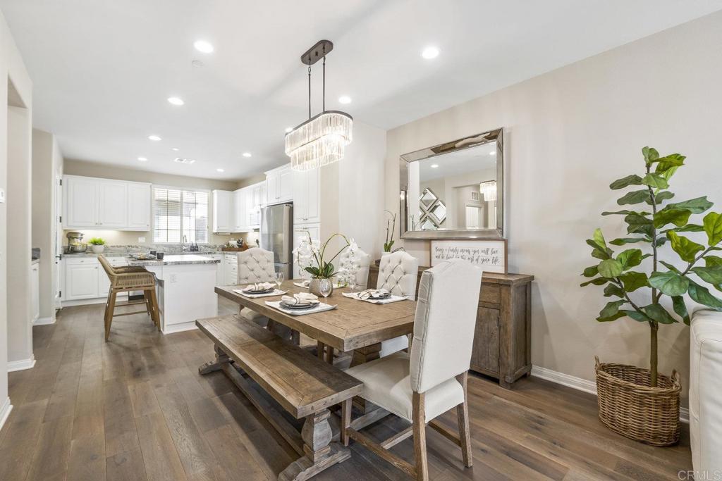 Located within the coveted gates of Veridian, this beautifully upgraded 4-bedroom, 4-bathroom townhome is sure to impress. Thoughtfully designed for comfort and versatility, the home features a bedroom and full bath on the entry level, plus an oversized storage closet —ideal for guests, multi-generational living, or a private home office. Access to the 2 car garage makes parking a breeze. From the moment you enter, the craftsmanship and attention to detail are undeniable. Rich oak wood flooring, modern white cabinetry, tall baseboards, and designer window treatments create an elegant, cohesive aesthetic. Every space reflects quality, with custom shades, designer light fixtures, ceiling fans, and recessed LED lighting enhancing both style and function. The open-concept second floor is an entertainer’s dream, showcasing a gourmet kitchen with an oversized island and bar seating, upgraded granite satin countertops, stylish backsplash, and designer lighting in the dining room. Additional cabinetry offers extra storage, while modern stainless-steel appliances complete the space with a sleek, upscale look. Outdoor enjoyment abounds with multiple spaces to unwind — a welcoming front patio, balcony off the kitchen, and another balcony adjoining the living area, each offering an abundance of natural light and the perfect setting for relaxed evenings or morning coffee. Upstairs, the primary suite serves as a serene retreat, featuring a peekaboo vista view from the oversized window, a walk-in closet and a spa-inspired bathroom with quartz counters and a porcelain-tiled walk-in shower. Two additional bedrooms are located nearby with convenient access to a well-appointed hall bath. Enjoy the convenient location of this home, just a short walk to the neighborhood playground for kids and private dog park for your four-legged family member! Residents within the Veridian neighborhood also have access to the community pool, spa and entertaining areas which include BBQ grills, firepits, and shared patio/lounging areas! Enjoy the great location that's within 5 miles of 72 restaurants and is less than 1 mile from grocery stores, gyms, and many other shops! Enjoy the beautiful Southern California weather with 27 golf courses, 19 parks, and 4 hiking reserves all within 10 miles! Walking distance to Del Norte High School this home is located in the award-winning Poway Unified School District! You can't beat this location just a quick few minutes to the I-15 and CA-56 freeways!