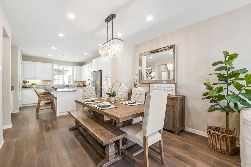 Located within the coveted gates of Veridian, this beautifully upgraded 4-bedroom, 4-bathroom townhome is sure to impress. Thoughtfully designed for comfort and versatility, the home features a bedroom and full bath on the entry level, plus an oversized storage closet —ideal for guests, multi-generational living, or a private home office. Access to the 2 car garage makes parking a breeze. From the moment you enter, the craftsmanship and attention to detail are undeniable. Rich oak wood flooring, modern white cabinetry, tall baseboards, and designer window treatments create an elegant, cohesive aesthetic. Every space reflects quality, with custom shades, designer light fixtures, ceiling fans, and recessed LED lighting enhancing both style and function. The open-concept second floor is an entertainer’s dream, showcasing a gourmet kitchen with an oversized island and bar seating, upgraded granite satin countertops, stylish backsplash, and designer lighting in the dining room. Additional cabinetry offers extra storage, while modern stainless-steel appliances complete the space with a sleek, upscale look. Outdoor enjoyment abounds with multiple spaces to unwind — a welcoming front patio, balcony off the kitchen, and another balcony adjoining the living area, each offering an abundance of natural light and the perfect setting for relaxed evenings or morning coffee. Upstairs, the primary suite serves as a serene retreat, featuring a peekaboo vista view from the oversized window, a walk-in closet and a spa-inspired bathroom with quartz counters and a porcelain-tiled walk-in shower. Two additional bedrooms are located nearby with convenient access to a well-appointed hall bath.  Enjoy the convenient location of this home, just a short walk to the neighborhood playground for kids and private dog park for your four-legged family member! Residents within the Veridian neighborhood also have access to the community pool, spa and entertaining areas which include BBQ grills, firepits, and shared patio/lounging areas! Enjoy the great location that's within 5 miles of 72 restaurants and is less than 1 mile from grocery stores, gyms, and many other shops! Enjoy the beautiful Southern California weather with 27 golf courses, 19 parks, and 4 hiking reserves all within 10 miles! Walking distance to Del Norte High School this home is located in the award-winning Poway Unified School District! You can't beat this location just a quick few minutes to the I-15 and CA-56 freeways!