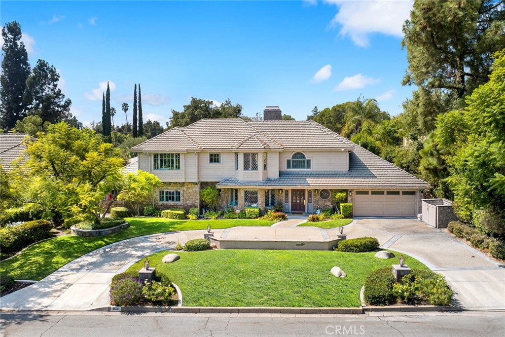 Discover this stunning tennis estate nestled in a prime North Arcadia neighborhood, boasting nearly 30,000 square feet of flat land and over 6,500 square feet of
stylish living space. Designed with family needs in mind, this exceptional home features vaulted ceilings and tennis court lights that are hard to find in today's
market. As you arrive via the expansive circular driveway, you'll be greeted by a grand two-story entryway. The home flows seamlessly from a cozy library into a
spacious living room with a fireplace, leading to an impressive great room with a beamed ceiling, grand fireplace, and sunken wet bar—perfect for entertaining or
family gatherings, filled with natural light. The first floor is entirely step-free, offering easy access to the park-like backyard. The gourmet kitchen, complete with
custom cabinetry, high-end appliances, dual dishwashers and ovens, and an ice maker, overlooks the outdoor space, creating an inviting open floor plan with a
connected dining area. A large laundry room with ample storage and a convenient bath/powder room are located just off the kitchen. This residence includes six
bedrooms, featuring two master suites—one on each level. The luxurious main-level master retreat boasts a sitting area with a third fireplace, two bathrooms,
three closets, and French doors leading to the backyard. Additionally, two spacious bedrooms are located on the first floor, one of which is currently an office. The
upper-level master suite features a generous walk-in closet, with two additional bedrooms sharing a large bathroom. Step outside to enjoy a spectacular outdoor
living area that includes a vast green space, fenced swimming pool and spa, regulation-sized lighted tennis court, and mature fruit trees. With a large patio
accessible from the kitchen, great room, and master suite, this home offers the ultimate indoor/outdoor living experience. Enjoy the privacy of this estate while
being conveniently located near top public and private schools, Westfield Shopping Mall, Santa Anita Race Track, L.A. Arboretum, golf courses, shops, restaurants,
parks, and easy access to the 210 Freeway.