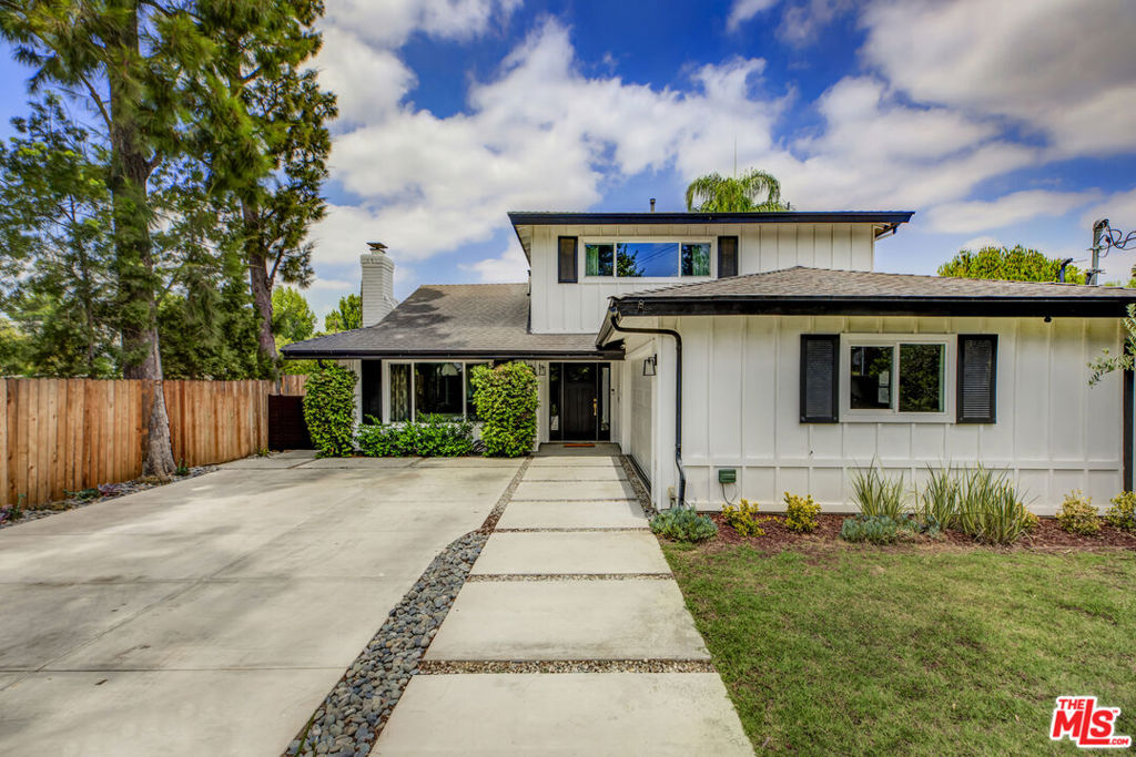 Step into this elegantly remodeled two-story home, where timeless design meets modern convenience that exudes warmth, style, and functionality. Bathed in natural light, the thoughtfully conceived floor plan features four generously-sized bedrooms and three full bathrooms, including a first-floor bedroom and full bath - ideal for guests, extended family, or a home office. Well-appointed interiors include a formal living room with a decorative fireplace, a dining room perfect for hosting, and a welcoming family room complete with a built-in cocktail bar for effortless entertaining. The open-concept kitchen is a chef's delight, showcasing sleek stainless-steel appliances, abundant pantry and counter space, and a convenient breakfast bar. Upstairs, discover three bedrooms, including a luxurious primary suite with a spa-like ensuite bath and a beautifully tailored closet system. Hardwood floors flow throughout, complemented by a Sonos surround sound system and elevated designer finishes that reflect impeccable attention to detail. Outside, the privately gated yard offers a tranquil retreat with drought-conscious landscaping, a sparkling pool, and multiple areas for lounging and entertaining. A two-car garage provides generous storage and the generously-sized driveway is wired for EV charging. Ideally located within a few blocks from a top-rated elementary school and mere minutes from the shops and restaurants at Sportsman's Lodge, Whole Foods, Westfield Sherman Oaks, and the 101 freeway, this is quintessential Sherman Oaks living at its finest.