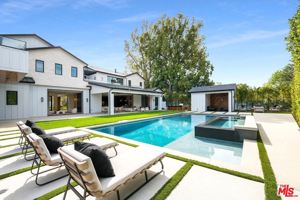 World class Encino Estate with captivating architecture spanning 9475 indoor-outdoor square feet of pure elegance and sophistication. Enter into the beautiful 2 story foyer showcasing soaring ceilings, a floating staircase and an incredible amount of natural light! Beyond the entry, the great room seamlessly flows into the striking kitchen outfitted in custom cabinetry, and top of the line appliances. Travel upstairs to the luxurious primary suite complete with a large balcony overlooking the stunning grounds, dual baths, and dual closets. Unmatched amenities including an additional 6 ensuite bedrooms, a large media room, office, gym, 2 glass encased temperature-controlled wine display refrigerators, bar and state of the art security system. Hosting an unmatched outdoor setting perfect for both entertaining and intimate settings, the backyard features a basketball court, an oversized pool with a spa, built-in barbeque, a spacious grass area as well as a firepit for complete entertainment. This masterpiece with unparalleled luxury & modern finishes is truly one of a kind!