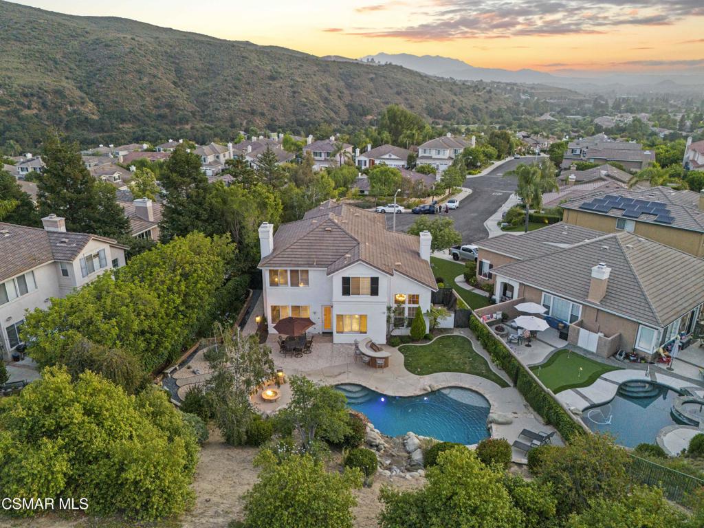 Exquisite Lang Ranch Estate with Unparalleled Views!Nestled at the end of a peaceful cul-de-sac on a sprawling nearly half acre lot, this exceptional Lang Ranch home is the epitome of luxury and sophistication. Combining elegance, modern design, and panoramic views, this home promises to be a true dream sanctuary.With 4 spacious bedrooms, a versatile office/bonus room, and 3 beautifully appointed bathrooms, this residence is designed for both comfort and style. The private backyard is an entertainer's paradise, featuring a sparkling lagoon style pool and spa with a cascading waterfall flowing over natural boulders, pebble tec finish and LED color changing pool all controlled via your smart phone. Lush landscaping features a large grassy area and a charming drought-tolerant garden. The front yard welcomes you with its mature birch trees, low-maintenance turf and fabulous curb appeal especially in the evening when everything is illuminated. An inviting front porch ushers you into a thoughtfully crafted interior, where soaring two-story ceilings in the formal living room create a dramatic first impression. The formal dining room offers the perfect setting for memorable gatherings, while the heart of the home--the Great Room--boasts an elegant contemporary bar with a KitchenAid wine fridge and a newly designed fireplace facade.The chef-inspired gourmet kitchen is a culinary dream, outfitted with top-tier stainless steel appliances, including a built-in SubZero fridge/freezer, Dacor double convection ovens, a 6-burner gas cooktop with a sleek vent hood, and Fisher & Paykel dishwasher drawers. A spacious center island, complete with a SubZero wine fridge, serves as the ideal hub for meal preparation and casual conversation. Enjoy custom cabinetry featuring soft close doors and drawers, pull out drawers throughout plus a double pantry. Overlooking the serene backyard, the cozy breakfast nook is seamlessly connected to the family room, creating an inviting space for both daily living and entertaining.Convenience is key with a downstairs bedroom and full bathroom, along with a custom-designed mudroom--perfect for keeping everyone organized. A newly updated, stunning contemporary staircase leads to the expansive Primary Suite, a true retreat offering breathtaking views of the backyard. This private oasis features dual vanities, a luxurious soaking tub, a separate stall shower, and an oversized walk-in closet with customized designer built-ins. Adjacent to the primary suite, a flexible bonus room awaits--ideal as an office, gym, or nursery. The additional upstairs bedrooms are spacious and equally impressive, each featuring walk-in closets and panoramic vistas that will leave you in awe.The pristine three-car garage is a masterpiece of functionality and style, featuring epoxy flooring, built-in storage, and a professionally installed Bosch EV charger. Whether you're parking your prized vehicles or creating the ultimate play space, workshop, or man cave, this space is as versatile as it is immaculate.Upgrades abound in this meticulously maintained home, including custom designer closets, 48 panel solar system, hardwood flooring, a state-of-the-art security system, newer tankless water heater and a newly remodeled fire pit--perfect for outdoor entertaining.This Lang Ranch gem offers the ideal blend of serenity and sophistication, creating a luxurious living environment perfect for both family life and grand entertaining. Don't miss your chance to experience the ultimate in Lang Ranch living.