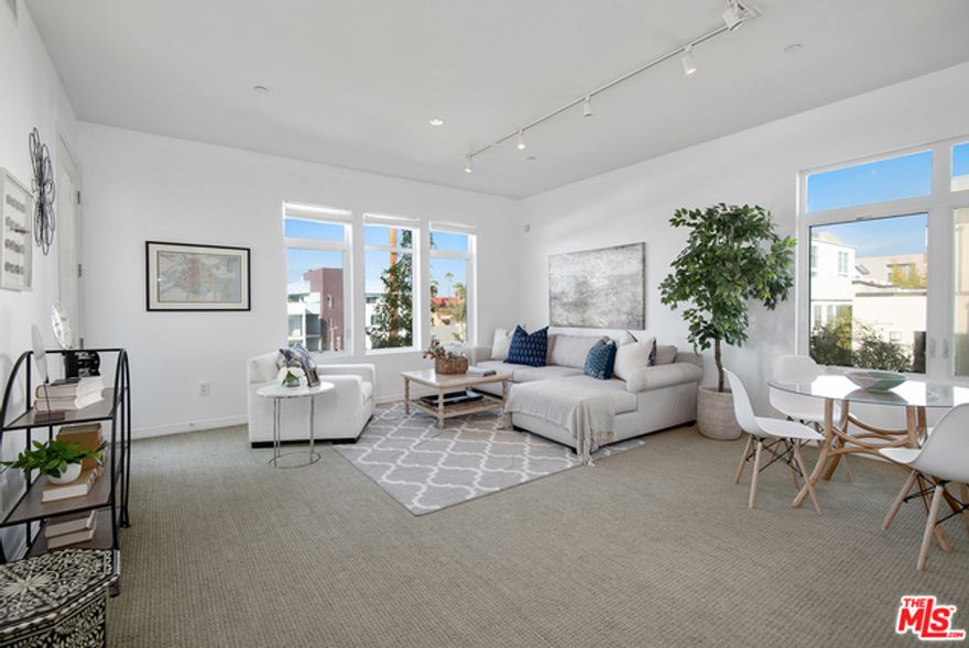 Sunlight fills this top-floor corner unit at the sought-after Indigo complex in the Marina Arts District. The open floor plan is light and airy, with high ceilings and walls of windows that frame the views. The kitchen features granite countertops, Viking stainless steel appliances, and rich wood cabinetry. The spacious primary suite offers two closets and a luxurious ensuite bathroom with a soaking tub, separate shower, and dual vanity. Both the living room and bedroom open to a private balcony, perfect for enjoying sunset views. Additional highlights include in-unit laundry, a powder room, and side-by-side parking. Indigo offers a full suite of amenities, including a gym, spa with hot tub and sauna, and landscaped courtyards with BBQs and a fire pit. Located in the heart of the Marina, you're just minutes from Silicon Beach, Abbot Kinney, great restaurants, shops, movie theaters, and the beach. Showings begin this weekend, October 4th & 5th.