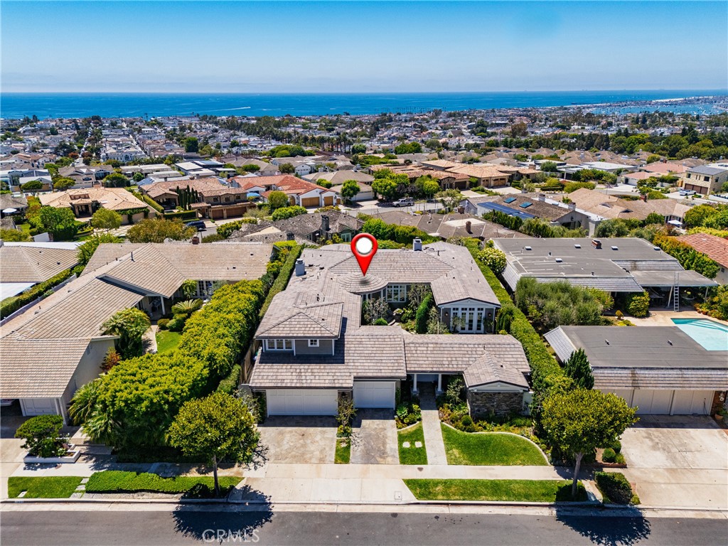 While residences of this caliber are RARELY offered for lease, this custom-built Cape Cod masterpiece with panoramic ocean, Catalina, Harbor and city light views, exudes quality and comfort from every vantage point, and could be yours to call home for the next year or two. Gorgeous solid wood floors which have just been refinished to their natural glory, exquisite gloss white millwork, high ceilings, artful lighting, and so much more. A great room concept allows seamless flow between the kitchen, nook area and even into the theater room. The kitchen offers a compliment of premium appliances, an abundance of custom cabinetry and stone counters, and even a butler's pantry for seamless large-scale entertaining. Formal dining is exquisite, complete with a gorgeous, temperature-controlled wine room. The primary bedroom enjoys sensational views and separation from all secondary bedrooms. This private wing is accompanied by an incredibly luxurious bath, walk-in closet, and an additional attached area which is the ideal location for a gym, nursery, office, meditation room. etc. There are two additional bedrooms in the main house, and a fully functional private detached casita just inside the courtyard gate. Gorgeous gardens, tranquil in-ground jacuzzi, plenty of privacy. Remote blinds, central air, surround sound, additional refrigerator wine storage in the 3-car garage, and a fully equipped security system add the "function" to the "form" found throughout this exceptional offering. Enjoy an unsurpassed living experience within full view of the Pacific Ocean, in an incredibly convenient, central location. This one is special.