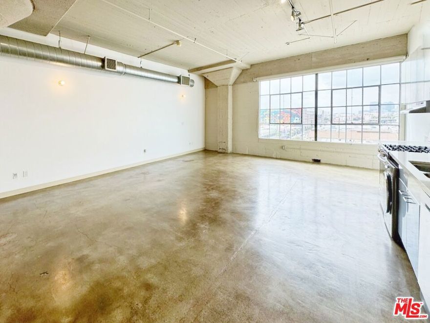Historic Toy Factory live/work loft in the heart of the Arts District. This open plan 6th floor loft features 11-foot ceilings, concrete floors, and massive factory windows stunning views of the DTLA skyline. Flex open plan living area of nearly 900sf allows for creative layouts to suit your needs. Spacious bathroom, stainless steel appliances, in-unit combo washer and dryer, central heat and AC. Rent includes 1 covered garage parking space. The beloved Toy Factory building features a stunning rooftop pool deck and cabanas, 360 degree views of DTLA, garden and lounge deck with BBQs, gym, 24/7 front desk reception, and in-building parking. You're within blocks of the best of the Arts District, including Soho House, Hank's Grocer, Camelia, Cafe 2001, Bestia, The Girl & Goat, Dover Street Market, Bavel, upcoming Holy Basil, Urth Cafe, Manuela, Hauser & Wirth, Geffen Contemporary, GROW market, Hennessy & Ingalls, Salt & Straw, Bavel, Metro, as well as nearby Little Tokyo and Disney Concert Hall, The Broad, Grand Central Market and more.