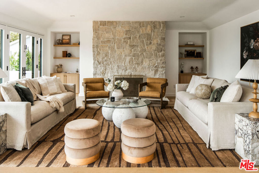 Nestled in the hills above the iconic Sunset Strip off a quiet street with lots of parking is this fully reimagined contemporary home that's been taken down to the studs with new roof, new electrical, new plumbing and brought back to life with flawless design and craftsmanship. The home features a light-filled layout designed for both comfort and style, with city views from living room, dining room and outdoor areas. The home features a mix of intimate and spacious rooms, thoughtfully redesigned with clean finishes and a warm, modern aesthetic. The kitchen connects to a breakfast nook and overlooks the outdoor spaces, while the living room offers a cozy setting with a wood burning fireplace and views stretching out to the city. Step outside to discover a brand new sparkling pool, spa and a generous landscaped yard with multiple areas for relaxing, dining, or entertaining under the stars. A standout feature is the fully detached guest house, complete with its own kitchen, bedroom, and bathroom which is perfect for visitors, a home office, a rental unit, or creative space. Located in the coveted Sunset Plaza enclave, this stylish and move-in-ready retreat offers the perfect blend of comfort, privacy, and classic LA charm. Main house is 3b/3.5bath and guest house is 1 bed/1 bath with living room and full kitchen.