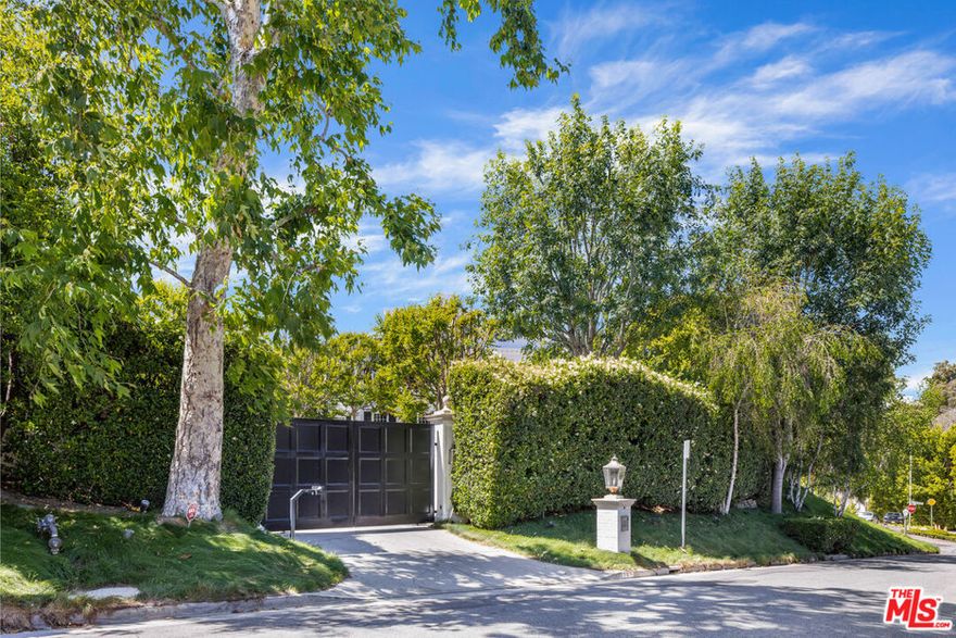 Located behind gates in the most prime section of Bel Air, a stunning Traditional estate originally built in 2006 and recently remodeled again. Featuring 5 bedrooms (plus 1 staff room) / 8 baths , almost 11,000 sf of very high quality construction designed by Richard Manion, the property is approximately 1.2 flat acres. It features a beautiful 2-story entry with a sweeping staircase, a large living room that converts into a professional theater, a large office/library, great family room connected to a gourmet chef's kitchen with center island, formal dining room, breakfast room, professional gym, and a large primary suite with sitting area and dual baths and closets. The property features a state-of-the-art security room and electronics throughout. There's a very large swimming pool, spa, huge lawns, formal gardens and a motorcourt. Rarely does an estate of this quality and magnitude become available for purchase.