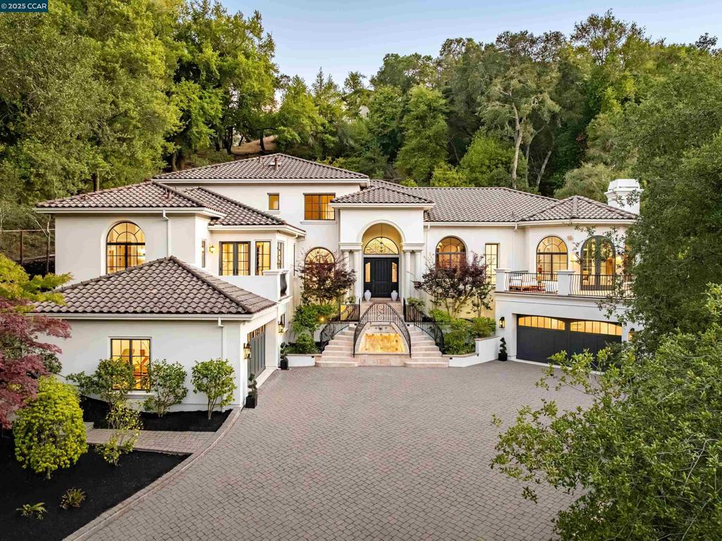 This Mediterranean estate is up a shady lane in Upper Happy Valley, removed from traffic and noise and yet with easy freeway access. The formal entertainment areas lie on each side of the foyer: a living room (with fireplace), and the dining room (seating 10 or more). Ceilings are 15-24 feet overhead, and hardwoods lie underneath. The oversized kitchen sits adjacent, featuring elite appliances, granite counters, an island with bar seating, dining area, skylight, and French doors to a patio and outdoor grill. The kitchen flows into the 506-sq-ft family room (with fireplace), which in turn accesses a terrace. Also on the main floor is a spacious office with fireplace and garden views. The principal bedroom, 432 sq ft, is on the main floor under an elevated ceiling. Its en-suite bath features dual sinks, a vanity, spa tub, oversized shower and huge walk-in closet. The other 4 spacious bedrooms and 3 bathrooms lie upstairs, along with a 500-sq-ft game room and wet bar (with refrigerator and dishwasher). The back yard features a terrace, deck, putting green and swimming pool. Parking is easy in two 2-car garages. Enter from a garage to a mud room, which adjoins the wine cellar. A gym is also off this garage. The tile roof affords fire protection, and the fire station is close by.
