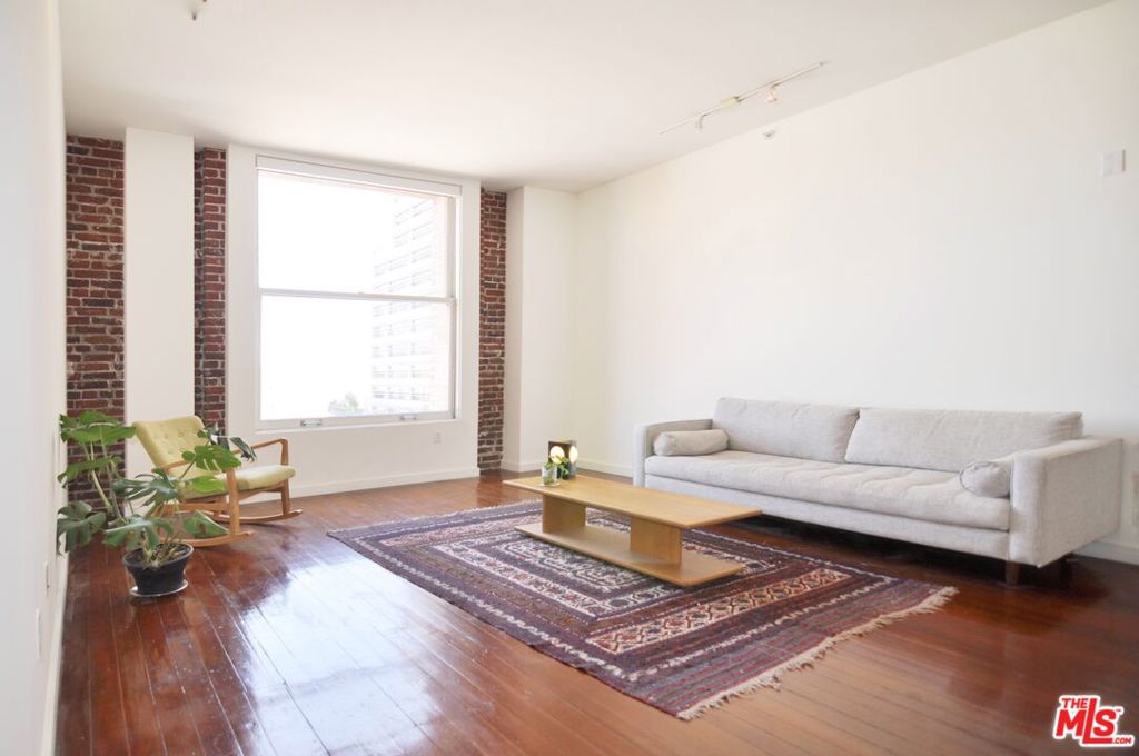 CHARMING 2 BED, 2 BATH LOFT w/ 1 RARE UNDERGROUND GARAGE PARKING INCLUDED! This unique loft in the famed Douglas Building is situated just below the Penthouse level, and features massive vintage restored windows that bring in tons of natural light and city views. Restored vintage hardwood floors, exposed brick walls, and tall ceilings add to the historic aesthetic of this loft. Two bedrooms, each bedroom completely private from the living and dining areas, fully enclosed, are conveniently located on opposite ends of the loft, making an ideal layout for a live/work setup. Each bedroom features large closets with built-ins and views to the east through massive double pane windows. There are two bathrooms, just outside each bedroom. The kitchen features Poggen Pohl cabinetry and stainless steel appliances, and a huge pantry for lots of storage. The open plan dining and living area makes it easy to entertain. Powerful central heat and AC unit, a stacked W/D inside a closet, entry coat closet, and the loft comes with 1 RARE ASSIGNED UNDERGROUND GARAGE PARKING SPACE in the building. The incredible location is just a few blocks from the Little Tokyo and Arts District, The Broad, Grand Central Market, Arts District, Financial District, Whole Foods, Walt Disney Concert Hall, The Broad Museum, MOCA, Spring Street Park, Spring Arcade, the iconic Bradbury Building with the exclusive Neuehouse members club, Dorothy Chandler Pavilion, the Frank Gehry-designed The Grand LA and Conrad Hotel, Metro station 1 block away, and so much more.