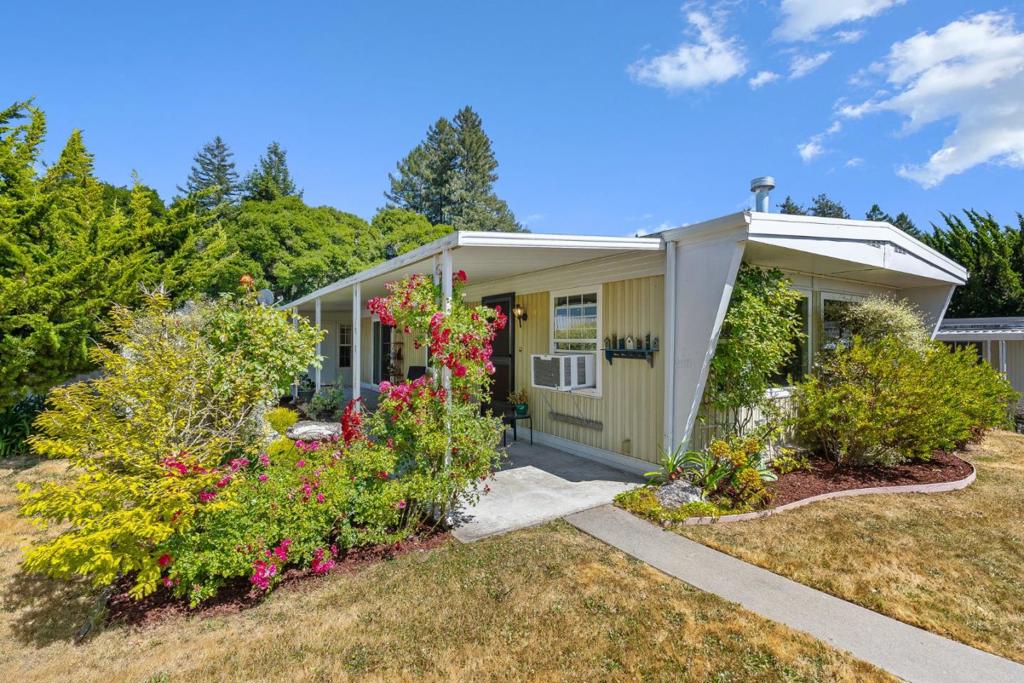 Located in highly desirable Aptos Knolls, an exclusive resident-owned 55+ community, this lovely home offers the perfect blend of comfort, convenience & natural beauty where redwoods, relaxation, & community come together. This beautifully cared-for 2-bedroom, 2-bath home offers approx. 1,200 sq ft of light-filled living space. The open layout features lg. picture windows, dining room w/ built-in cabinetry & a well-designed kitchen w/ abundant storage. The 2nd bedroom includes a built-in desk, shelves & closet making it perfect for guests or a workspace. The expansive primary suite includes a walk-in closet, 2nd lg. closet & private sitting room w/direct access to the patio, perfect for morning coffee! An indoor laundry rm. w/ door leading to the carport, adds everyday convenience. Step outside to a covered patio surrounded by lush, peaceful landscaping. Residents enjoy access to a private clubhouse overlooking the redwood forest, complete with pool, hot tub, gym & library. The clubhouse is available for private events. Meandering trails wind through lush gardens & majestic redwoods throughout the property. Close to Aptos Village & Nisene Marks State Park, and only a five-minute drive to Rio Del Mar or Seacliff Beaches, this location offers the very best of the "Aptos lifestyle."