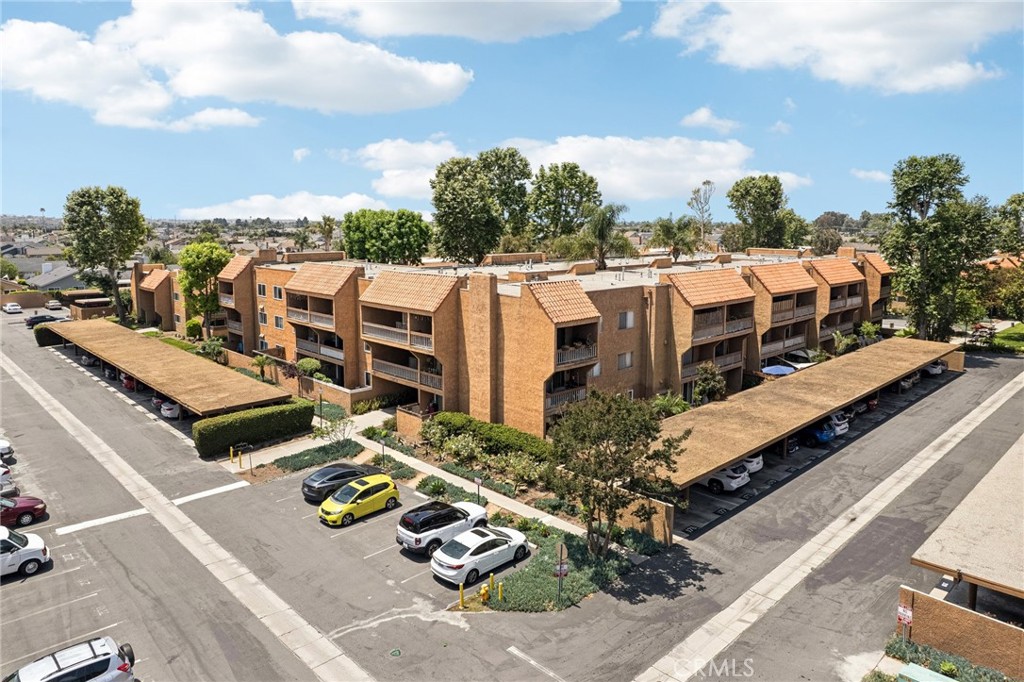 Turnkey Coastal Living at Villa Warner! This bright and private ground-floor corner unit features 2 deeded parking spaces, 1 bedroom, and 1 updated bath; the one uncovered parking spot and one carport are a rare find! Enjoy a spacious living area with views and access to an extra-large private patio and garden, allowing you to appreciate the coastal weather Huntington Beach has to offer. This bedroom unit is unique in this complex with its added walk-in closet, designed by California Closets to maximize storage. The remodeled kitchen boasts granite countertops, soft-close Shaker cabinets, built in microwave, dishwasher, updated lighting and laminate flooring. Upgrades continue in the bathroom with quartz counters, modern vanity, laminate flooring and updated lighting. Milgard dual-pane windows, an oversized slider, and ceiling fans add year-round comfort. Includes an additional storage unit in the common area storage room and easy access to a convenient community laundry room.
Resort-style amenities include gated entry, pool, spa, fitness center, clubhouse, billiards/game room, BBQs, and lush greenbelts. Prime location near schools, restaurants, shops, Central Park, Central Library, the Equestrian Center, Senior Center, Sports Complex, Bella Terra, Bolsa Chica wetlands; and of course, is just minutes to Bolsa Chica, Sunset, and Huntington State Beaches! HOA dues include gas, water, and trash in addition to the standard coverages!