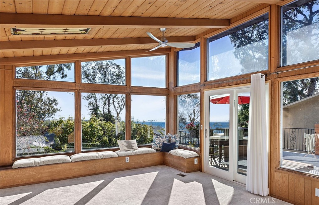 Views of the Laguna coastline, Surf & Sand resort, panoramic blue water ocean and wilderness areas are enjoyed from this home. Situated in desirable Top of the World neighborhood with proximity just yards to parks, trails and Top of the World elementary school. Come experience the serenity of private Ann's Lane, surrounded by mature trees and sunny skies. Contemporary updated open concept living, dining and kitchen spaces. Modern glass paned front door leads into the inviting living room, adorned with ocean view windows, floating cabinetry and a gas burning crystal rock fireplace with smooth plaster surround. The dining room looks out to a sunny courtyard and features gorgeous starburst crystal chandelier lighting. Large kitchen appointed with stainless steel Krause oversized Farmhouse sink with gooseneck fixture, appliances including dishwasher, gas burning range and French door refrigerator freezer. Granite countertops and glass tiled backsplashes, including bar seating. Plentiful storage via custom cabinetry with stainless pulls, along with a walk-in pantry / flex room large enough for a desk space. Well designed floor plan lives mostly on one level with two sizeable bedrooms and two bathrooms. The upstairs great room can serve as a third bedroom with wall-to-wall closet storage and built-in desk. This upper level room has a wide spanning ocean view, high vaulted ceilings and slider to an ocean view deck. Additional outdoor spaces include the bright front porch and rear patio with space to dine al fresco, complete with built-in barbecue. This home features updated systems, inclusive of a whole house Pex plumbing re-pipe, replaced water heater, furnace and air conditioning. The two car direct-access garage is conveniently off the kitchen and has a high ceiling, deep depth and additional parking provided by the two car driveway. The tree lined street is a respite from the bustle of town, yet in minutes you can transport to beaches, restaurants, shops, downtown and more. Award winning LBUSD elementary, middle and high schools are all within minutes of this location. Close proximity to Aliso & Wood Canyons Wilderness Area, to enjoy the natural open space trails with extraordinary vistas of Laguna Beach. A rare offering on Ann's Lane to call your new Laguna residence.