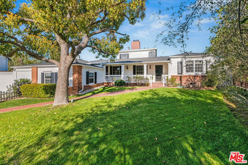 Charming storybook traditional located on a coveted street south of the boulevard. This Conneticut style home sits behind a white picket fence with an idyllic porch, and has an oversized 12,500 sq ft lot. The home boasts a new state of the art Chef's kitchen, beamed ceilings in the living room, paneled family room with additional fireplace, bookcases, built-in storage, expansive windows, window seat, and French doors to covered patio overlooking pool/spa with brick decking. Charming eat-in country kitchen. Formal dining room. Hardwood floors. Master suite with paneled sitting room/study and en suite bath. One additional bedroom plus bath on main floor plus generous third bedroom suite on second level with deck overlooking pool area. Over-sized Bonus room can be used as an office/playroom or 4th bedroom. Near Harvard-Westlake, Buckley, and Dixie Canyon Community Charter schools and all the shops/restaurants on Ventura Blvd.