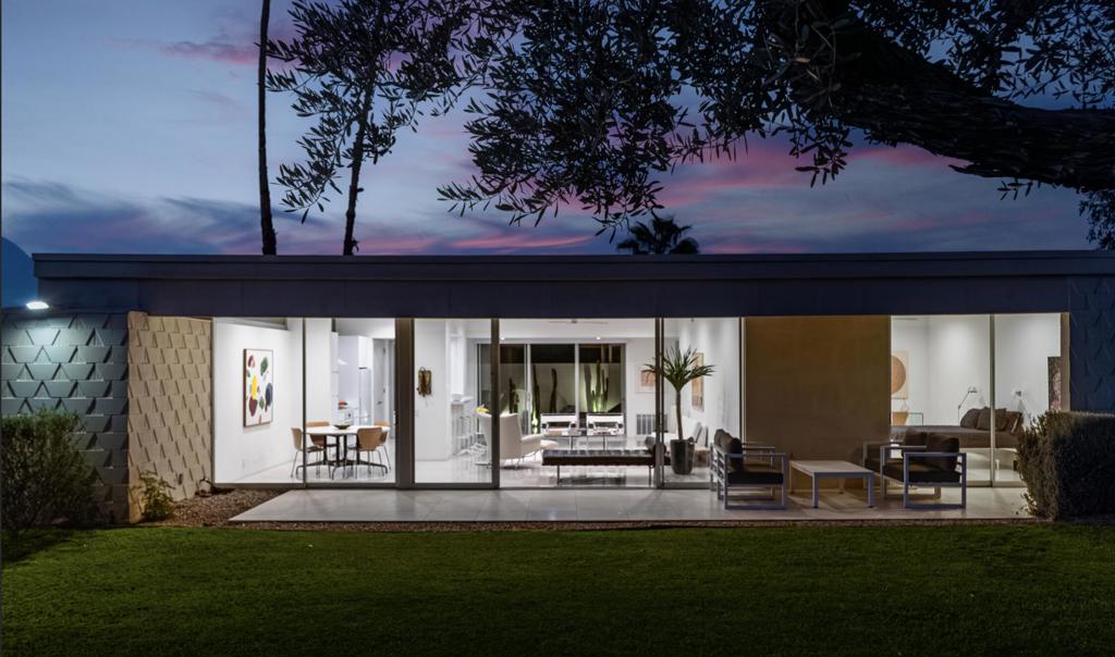 Step out of the warm desert sun and into the cool tones of a modernist getaway. This tranquil 2bed/2bath, in the desirable Seven Lakes Country Club, originally designed by Richard A. Harrison in 1967, has been thoughtfully reimagined as an elevated architectural gem. Inside its shadow-blocked walls, you'll be impressed by the home's minimalist style and spacious floor plan. Custom gallery walls display your personal artwork, while terrazzo tile flooring is highlighted with new lighting and ceiling fans throughout. The expanded new kitchen opens into the living and dining areas, adding a breakfast bar, with handsome Fisher & Paykel appliances blending into custom cabinetry and quartz counters. Walls of glass sliders lead to a green leisure terrace with views of mountains and iconic Southridge. The private courtyard, accessible from the living areas and secondary bedroom, is enclosed for maximum privacy and finished with new tile floors and dramatic landscape lighting. Spacious bedrooms offer sleek custom closets, including a built-in work from home space. Both bathrooms offer quartz counters, custom vanities and minimalist stacked tile walls. The primary has a large walk in shower and dual sinks with lit mirrors, while the guest bath has a Roman soaking tub. A new electric panel powers the Tesla EV charging station inside your covered parking. New roof, water softener and custom window coverings complete this perfect picture. Plus, your pool escape is just steps away. Past the 24-hour guarded gate, 'The Gem of the Desert' offers a unique elevated lifestyle with its Ted Robinson-designed 18-hole executive golf course, 15 pools and spas and lively William Cody designed clubhouse waiting to welcome you to its formal dining room, casual cocktail lounge and a terrace overlooking the famous Seven Lakes fountain. Welcome home!