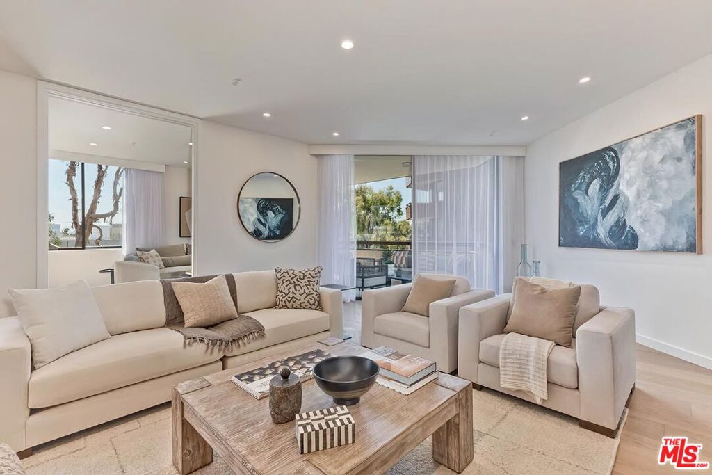 Presenting an exclusive opportunity for discerning buyers: a condominium at the esteemed IV Seasons North Condominiums in Beverly Hills. Reenvisioned by an internationally published and nationally award-winning architect, this residence features a tasteful aesthetic and soft color palette complemented by elegant architectural details. Upon entering through the formal foyer, you'll find a well-appointed living room with a custom fireplace and cabinetry, an adjacent formal dining room, and a gourmet kitchen equipped with top-of-the-line appliances, custom cabinetry, and a breakfast area. The expansive living and breakfast room terraces provide serene tree-top, city, and mountain views, enhancing the seamless indoor-outdoor flow of the residence. The primary suite serves as a private retreat, complete with dual custom walk-in closets and a spa-inspired bath with designer finishes, a soaking tub, a glass-enclosed stall shower, a linen closet, and a private water closet. The spacious secondary guest suite includes 2 closets and a modern en-suite bath. A versatile den offers space for a home office, media room, or additional living area. The redesigned in-unit laundry room adds convenience and houses new HVAC equipment. Residents of IV Seasons North Condominiums enjoy luxury amenities, including 24/ 7 doormen, valet parking, a newly updated pool and spa, a gym, and secure storage. The central Beverly Hills location offers proximity to the vibrant dining, and shopping scenes of Beverly Hills & Century City, West Hollywood's nightlife and dining, the upscale Melrose design and couture shopping district, and the arts and culture of Los Angeles.