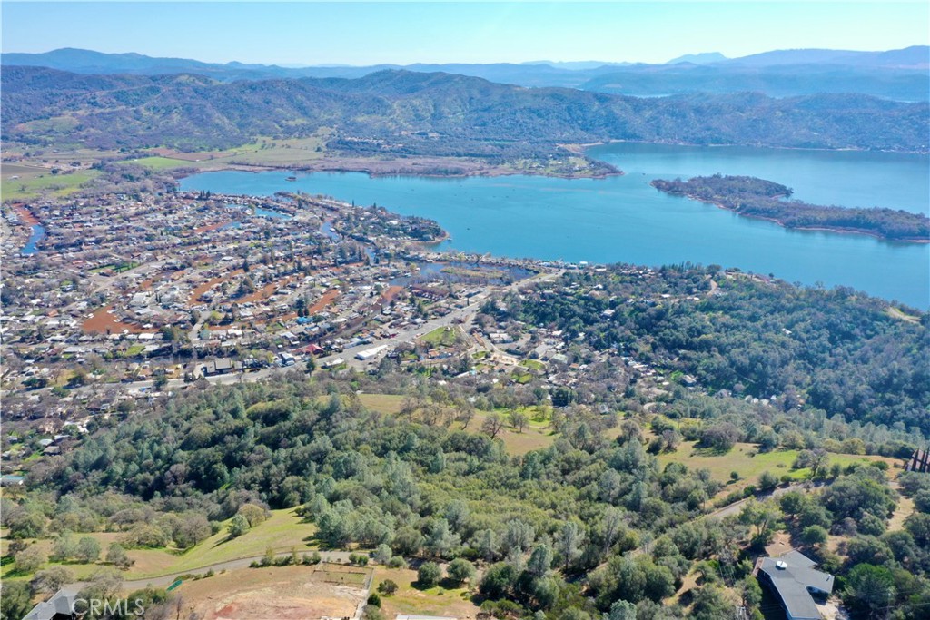 Motivated Seller! Atop a serene hillside where the world unfolds before your eyes lies an extraordinary opportunity to claim your little slice of paradise to build your dream home. This exquisite 6.34 acre vacant lot offers plenty of room to spread out and experience a birds eye view from your vantage point high above the city lights and overlooking the lake and mountains. Here is your invitation to a lifestyle that harmonizes with nature's rhythms as you escape the busy city life and embrace all that Lake County has to offer, home to Tule Elk, more than 150 bird species, an abundance of nature, hiking, biking trails and community activities. Fishing doesn't get much better than on the waters of Clear Lake with Bassmaster ranking it as #2 for bass fishing. Wind your way up this paved road to the lot with many beautiful surrounding homes already in place. Bring your plans and dreams to make this location your own. Close to shopping, wineries, gas, town and an easy 1.5 hour drive to Sacramento. Water availability in the area. Clearlake Oaks Water District is currently verifying this information for distance to main and cost involved. 707-998-3322. Listing Agent will update when any information is given but buyer to verify all property lines and utilities available.
BONUS: Also included is a sister parcel channel lot, 13513 E Highway 20, Clearlake Oaks CA APN: 035-782-570-000 with possible lake access.