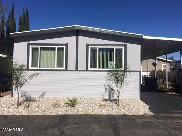 Motivated seller. Now a three bedroom! Nestled in a beautiful park located with a view of the surrounding mountains this lovely manufactured home is quite the gem with modern upgrades!This 3/2 bath home has security screen doors on both doors, dual paned energy star rated windows and stainless steel appliances. You will enter into a large modern living room with gorgeous faux wood flooring and a coat closet. There is spacious living room with a nook for a entertainment/bar area and two large windows for ample light. You pass through to the large entertainers delight modern kitchen with a black granite island with storage and pendant lights. A new stainless steel modern dishwasher and a gas stainless steel stove with a built in stainless microwave (new). A great kitchen window over the sink and a large pantry. The kitchen is open to a dining room with a ceiling fan. There is an eat - in kitchen with a closet and another small pantry close for ample storage. There are two bathrooms, one jack - n - jill hall bath with a shower and the other Primary bedroom has an en suite large bathroom with a standing shower and a large bathtub. There is a gate to the yard on the carport side great for entertaining and bbqing! A large shed for storage. There is a ramp off the deck at the front entrance side. A powerful 220 volt outside outlet has been added for outdoor patio electricity. Three Sheds, storage underneath house as well. Peaceful spot in the park. Great for generator if needed.