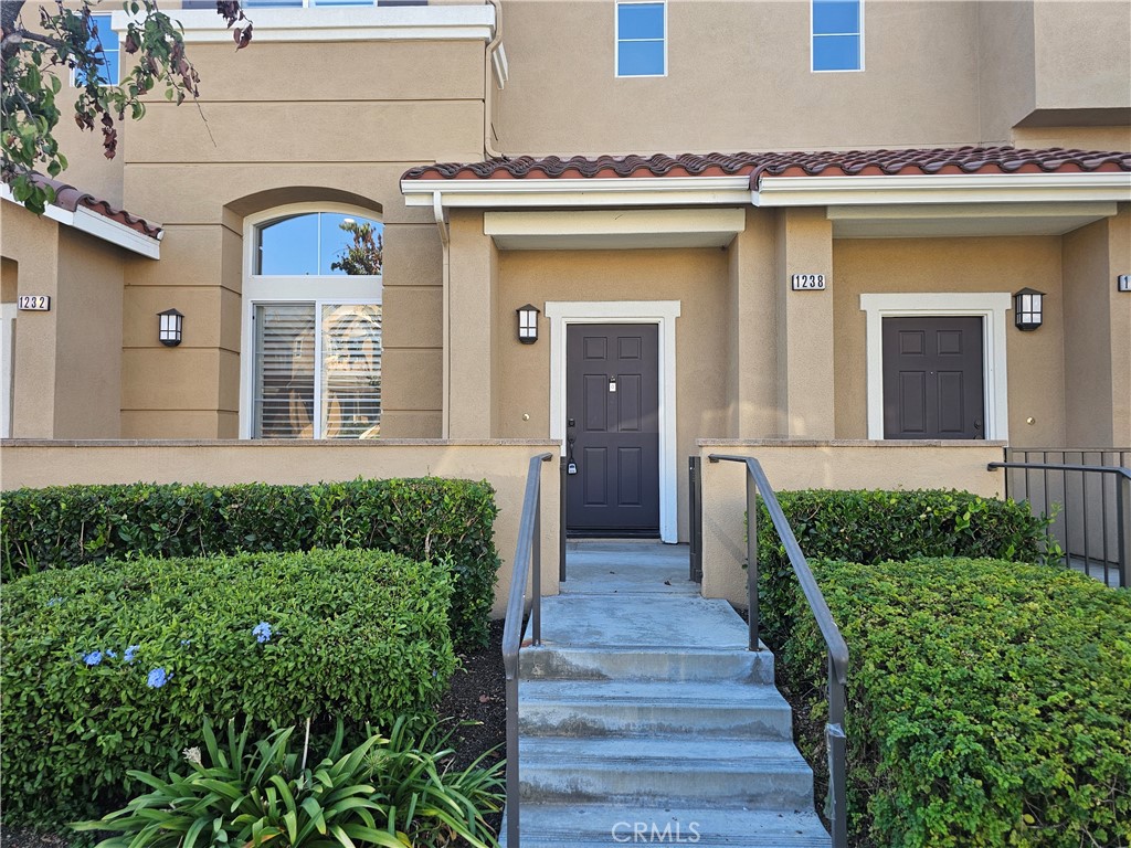 Beautiful townhome in the highly desirable Amerige Heights community of Fullerton! Nestled in a quiet neighborhood, this home features 3 bedrooms and 2.5 bathrooms. Within walking distance are top-rated schools including Montessori & Education Center, Robert C. Fisler (K–8), and Sunny Hills High School. Upgrades include custom laminate wood flooring and plantation shutters throughout. The bright kitchen boasts quartz countertops, a center island, and crisp white cabinetry, opening to a dining area accented by a stylish chandelier. The spacious living room offers a cozy fireplace and direct access to a private front patio. Upstairs, the primary suite showcases dual sinks and a generous walk-in closet. Additional highlights include a two-car attached garage with EV outlet, and HOA-covered high-speed internet. Community amenities—just steps away—include a pool, spa, parks, BBQ area, and more. Conveniently located near shopping, dining, and entertainment, this home blends modern comfort with an unbeatable location.