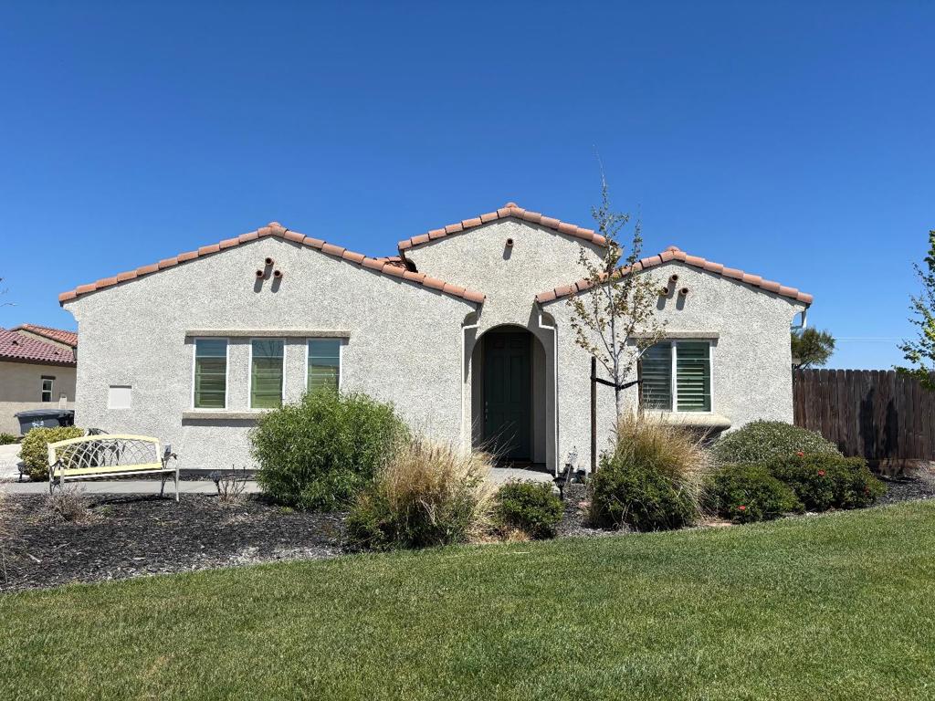 This former model home is stunning and situated in a 55+ gated community! Upgraded kitchen with stainless appliances, quartz countertop w/tile backsplash, pantry, plantation shutters, tile flooring throughout main traffic areas, wainscoting, can lighting, surround sound, ceiling fans, larger laundry room with wash basin, 2 car attached garage, slate backyard patio......all packaged in a single story floorpan! You must see this home for yourself!
