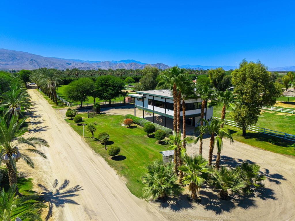 Rare offering in the gated community of Deer Creek, renowned for Palermo-quality polo fields and ranchettes catering to the Equestrian.If you are looking for an ordinary house in an ordinary community, this is not for you. But if your life's dream is to live in a tight knit community of like-minded horse enthusiasts, keep reading! Deer Creek was founded by William Devane in the mid 80's and consists of 17 ranchettes. On offer is a 5+ acre ranchette with a Neutra-style architecturally influenced home with fabulous views and natural light. Living is on the upper level, the lower is a covered carport. For the serious horse owner, the amenities are unmatched:*One-bedroom casita with kitchenette - ideal for guests, staff or extended stays.*Three barns - each with currently set up with 10-11 oversized stalls, double sized run-out stalls on the East side*Two tack rooms per barn - thoughtfully designed for convenience (total 6 tack rooms)*Five expansive turn out paddocks- offering space and freedom for your horses.*Additional covered structure at rear at property for housing RV's, tractors, cars, equipment.*Two player's tickets included - granting you access to the polo lifestyle that defines Deer Creek.This estate is more than a home--it's a lifestyle for those who live and breathe the equestrian tradition located in an area of Coachella Valley renowned for horse activities. Note that the size of the facility may allow for your own horses and the ability to 'income produce' due to size and number of barns, stalls and paddocks