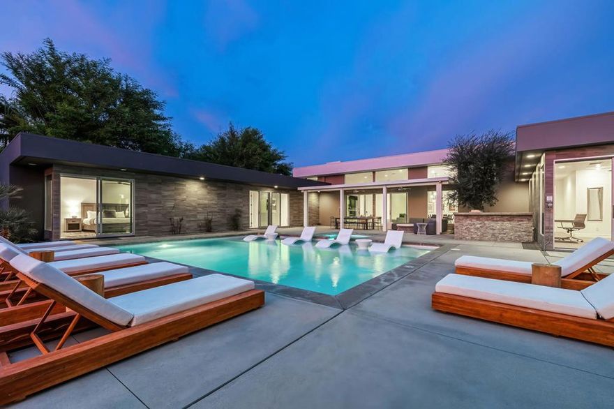 Nestled in the prestigious Polo Villas neighborhood in La Quinta, this striking contemporary estate offers the perfect blend of luxury and comfort. With 6 bedrooms and 6.5 bathrooms, this 3,636 sq ft home is an entertainer's dream. Featuring clean, modern lines and architecture, the home boasts soaring ceilings and a host of high-end amenities. Set on an oversized lot, the home provides plenty of outdoor space, including a luxurious pool and spa area, a 3-hole putting courses, outdoor kitchen and an inviting outdoor firepit--perfect for entertaining or simply unwinding in style. Upon entering, you're immediately drawn to the open-concept living area, which is thoughtfully designed with elevated furnishings, and cozy fireplace creating an ideal space for gatherings. The home offers two master suites, each with en-suite bathrooms and large walk-in closets, ensuring maximum comfort and privacy. The remaining four bedrooms also include their own private bathrooms, making it a perfect setting for family or guests. Additional amenities include a private, gated community, solar energy system, Level 2 EV charger, and most importantly, short-term vacation rental approved in the city of La Quinta, offering flexibility for both personal use and investment. This villa truly delivers the ultimate in modern luxury living, with an emphasis on comfort, privacy, and style. A must see when looking to add to your investment portfolio or for your new desert retreat.